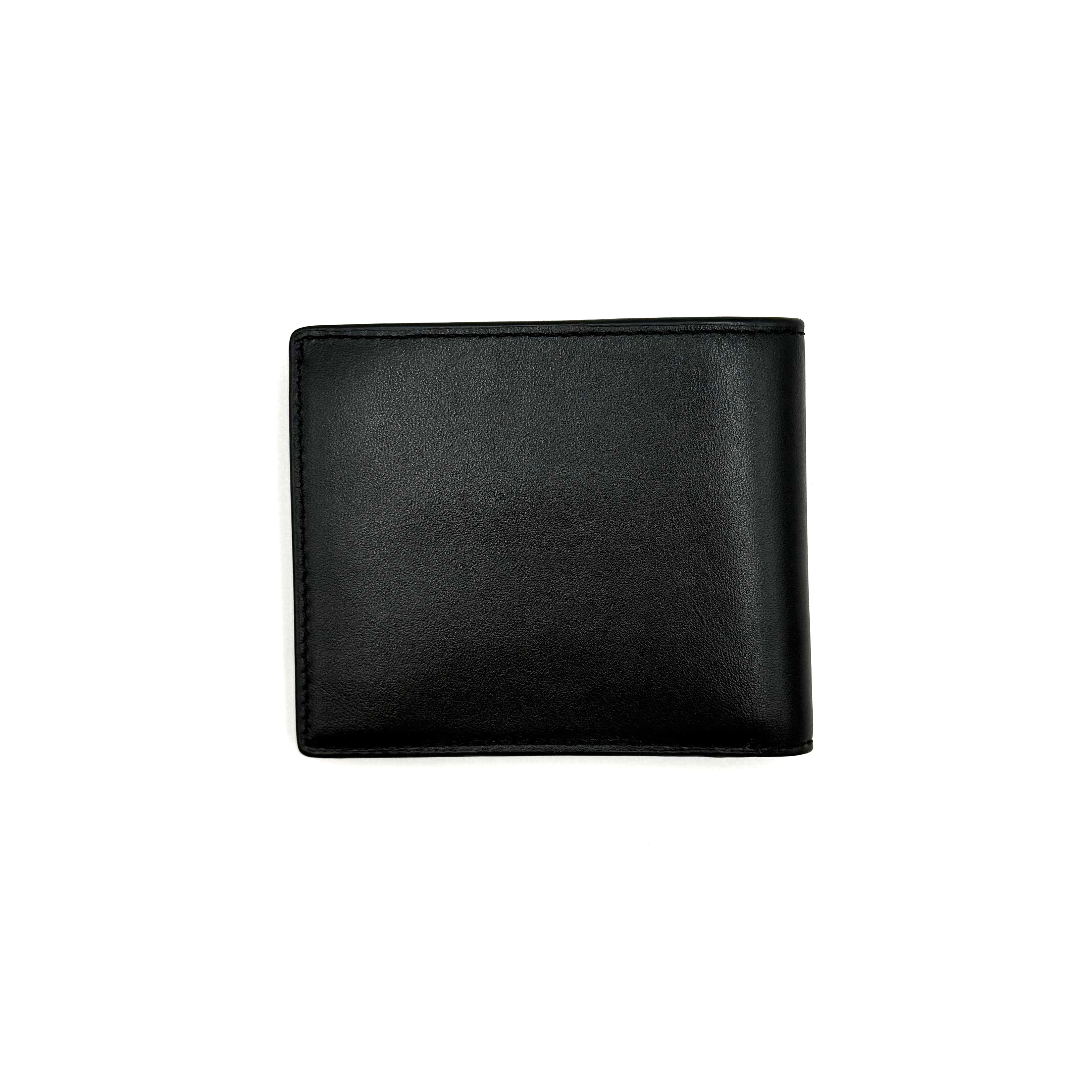 Furla Man Cosmo black leather bifold wallet with a textured teddy bear patch on the front.
