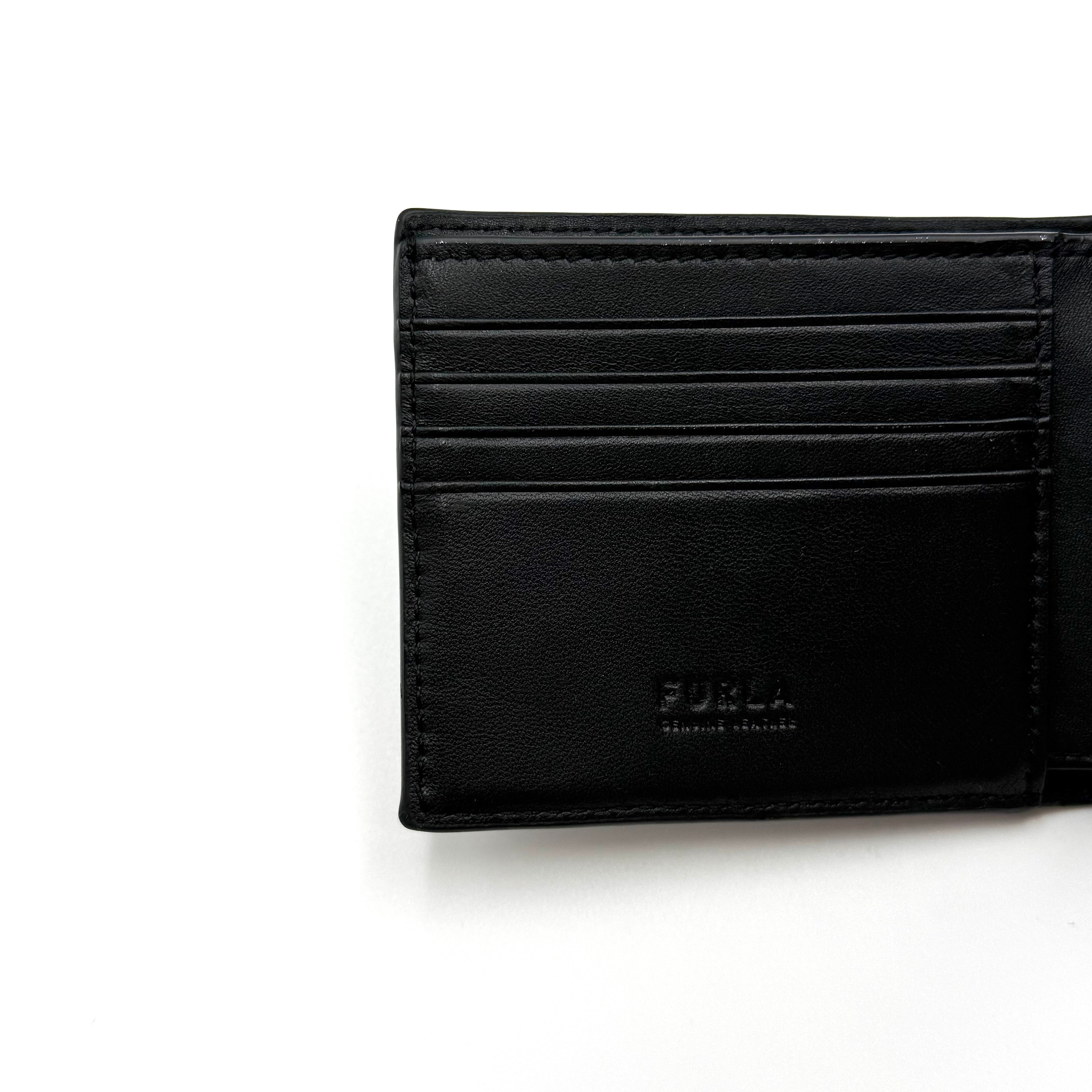 Furla Man Cosmo black leather bifold wallet with a textured teddy bear patch on the front.