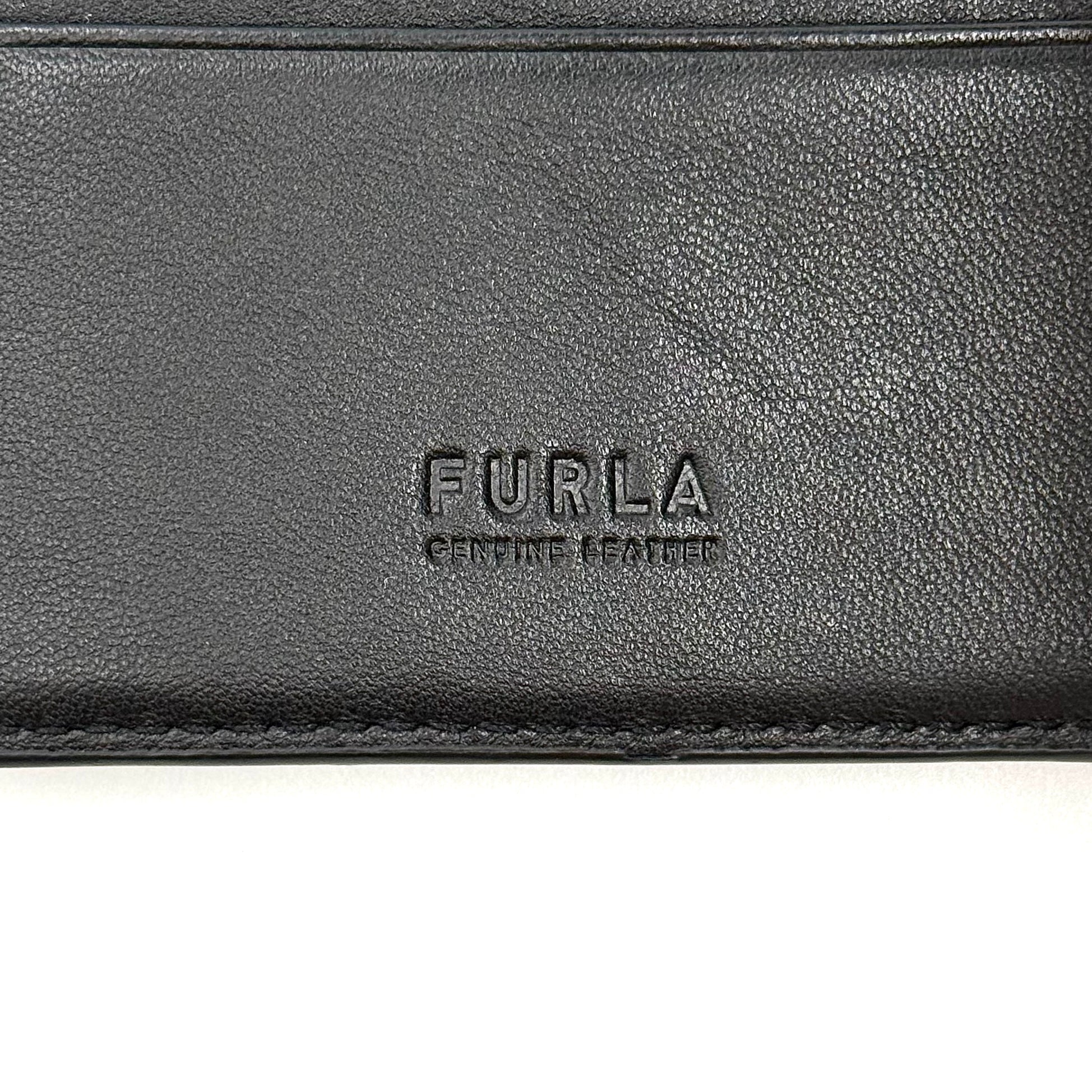 Furla Man Cosmo black leather bifold wallet with a textured teddy bear patch on the front.