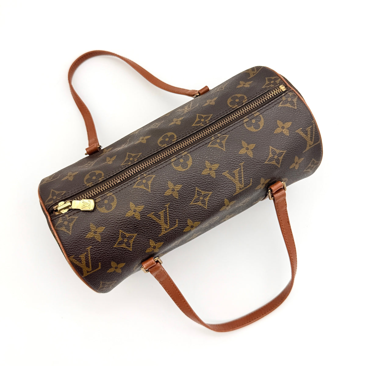 Louis Vuitton Papillon 26 in monogram canvas with leather handles and gold zipper, shown on a white background.