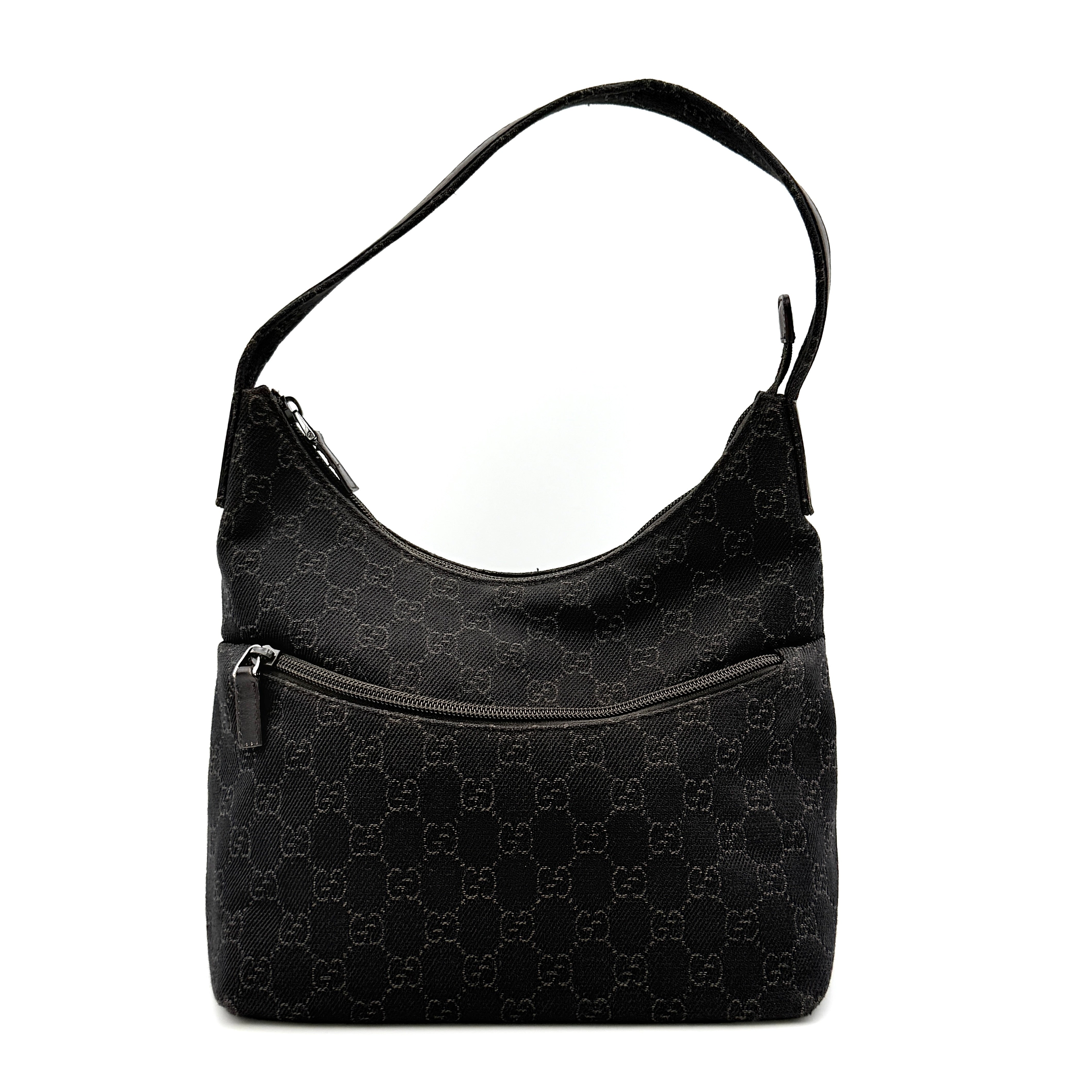 A brown Gucci GG Monogram Hobo Shoulder Bag with a single shoulder strap, styled on a matching GG dust bag.