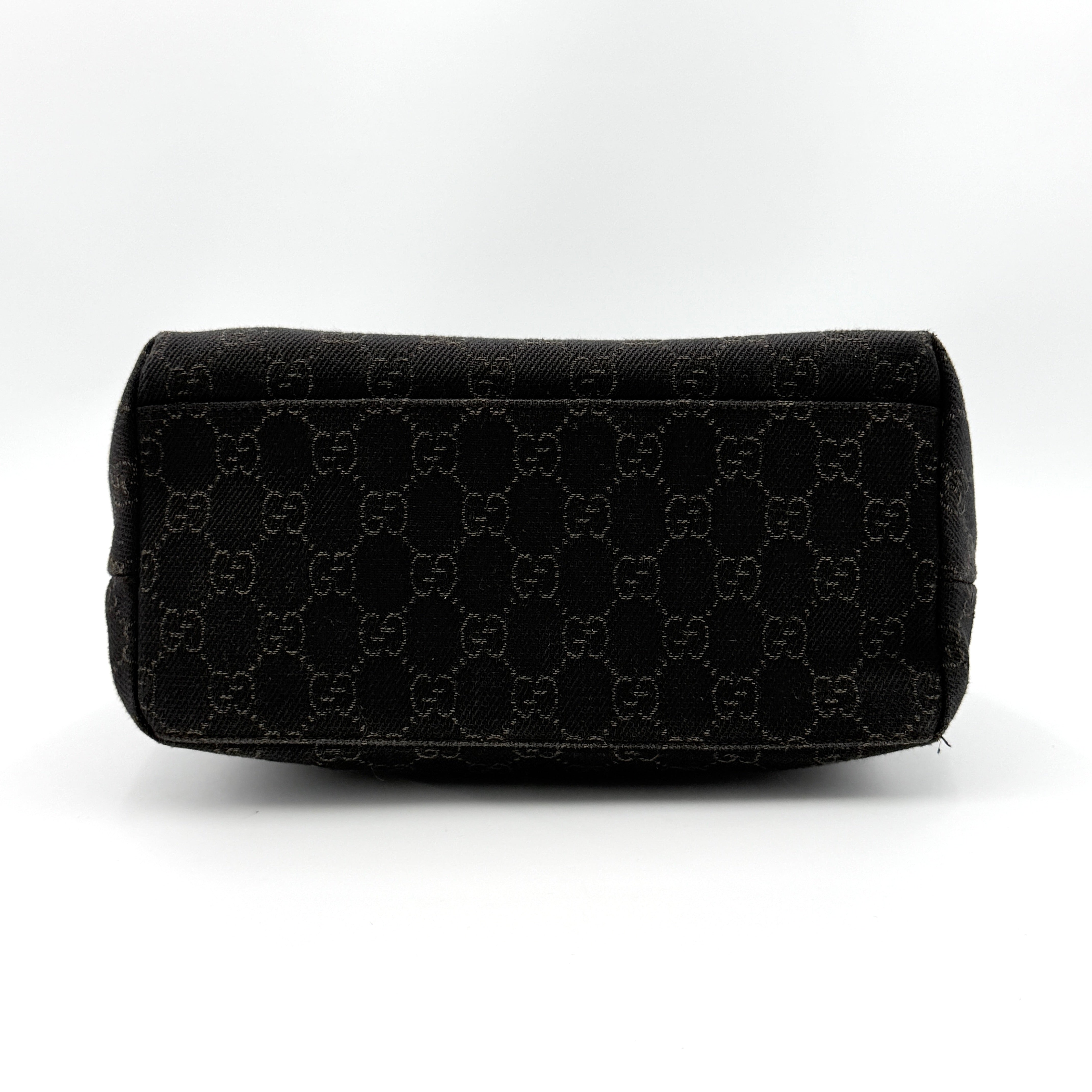 A brown Gucci GG Monogram Hobo Shoulder Bag with a single shoulder strap, styled on a matching GG dust bag.