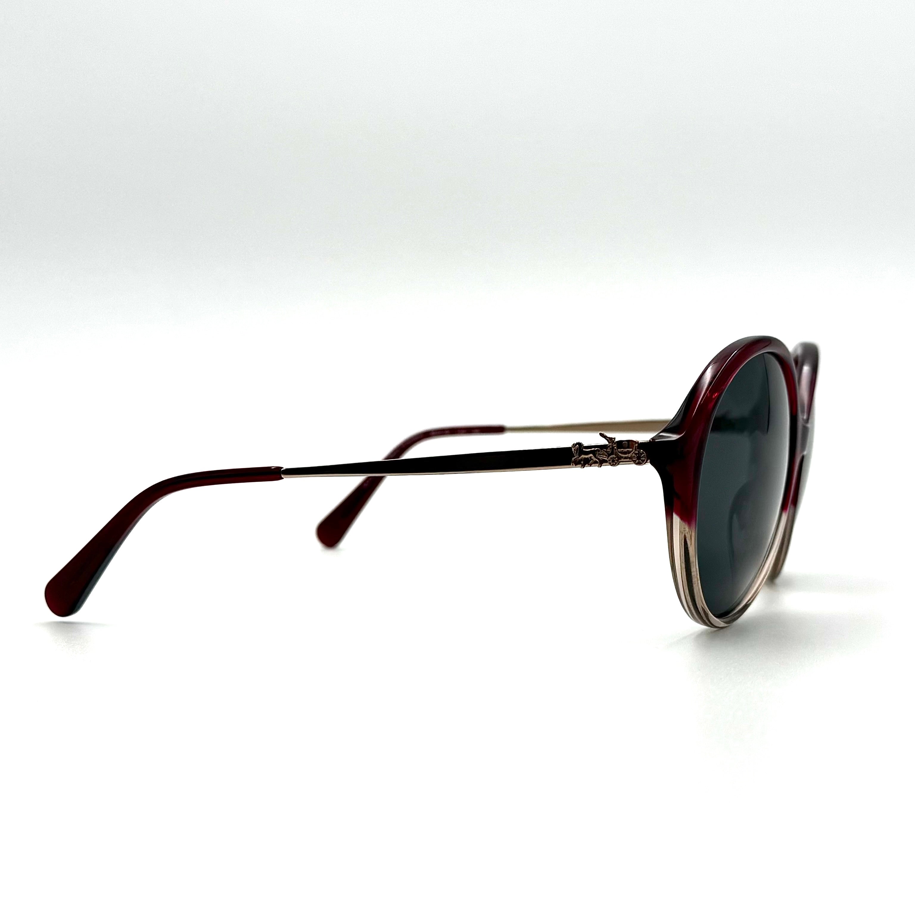 Coach HC8214F sunglasses in a red-to-sand gradient acetate frame with gold-tone metal temples and signature carriage detail.
