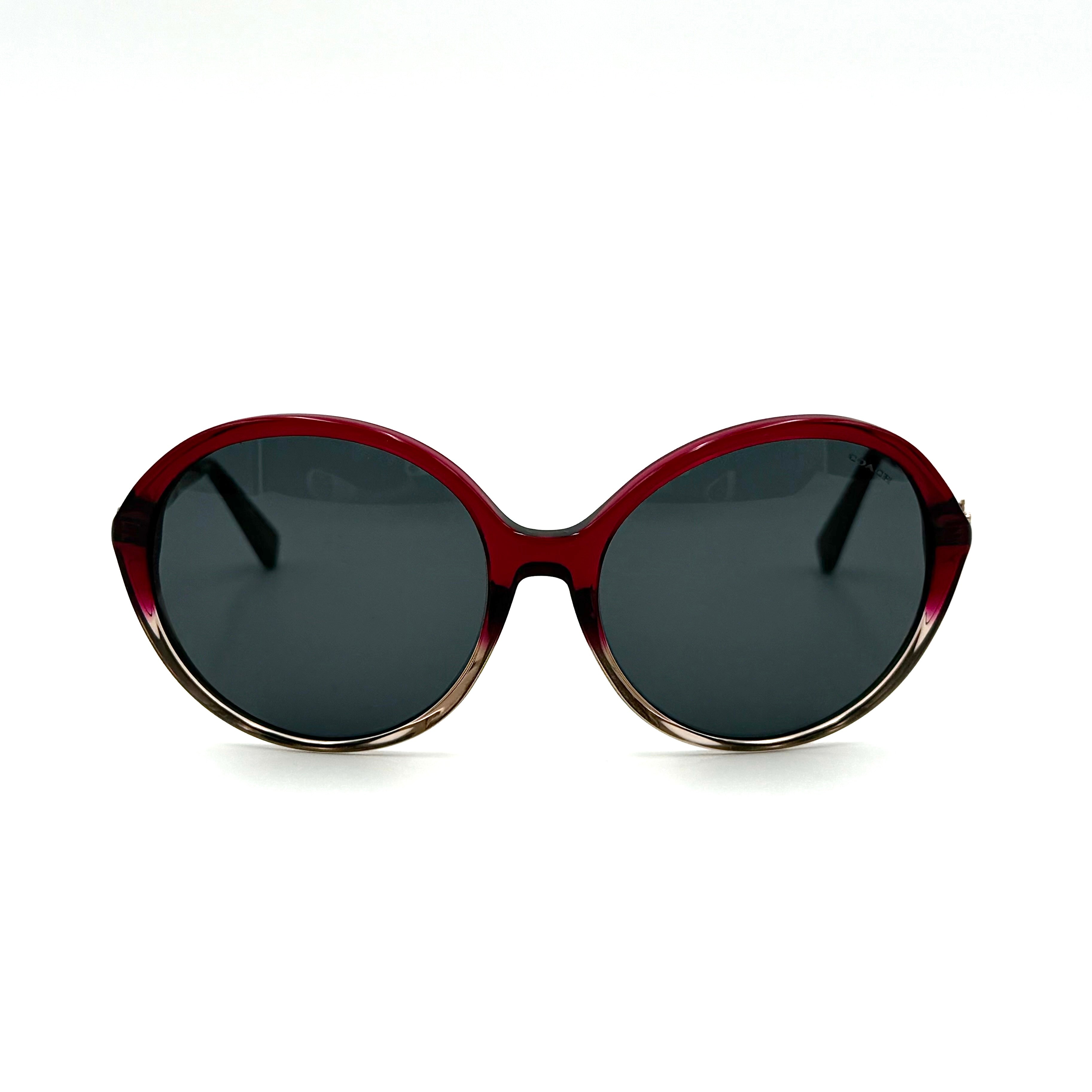 Coach HC8214F sunglasses in a red-to-sand gradient acetate frame with gold-tone metal temples and signature carriage detail.