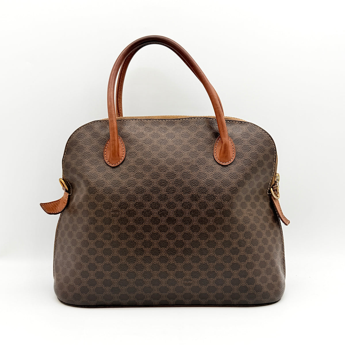 Celine Triomphe Macadam Dome Handbag in brown coated canvas with tan leather handles, shown against a white background.