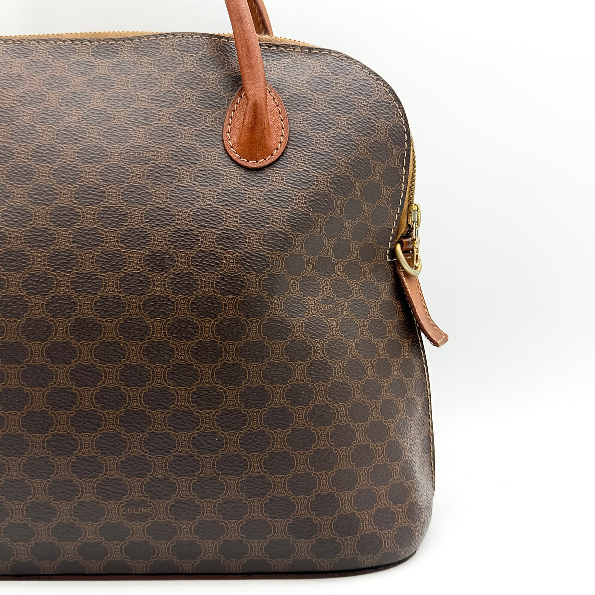 Celine Triomphe Macadam Dome Handbag in brown coated canvas with tan leather handles, shown against a white background.