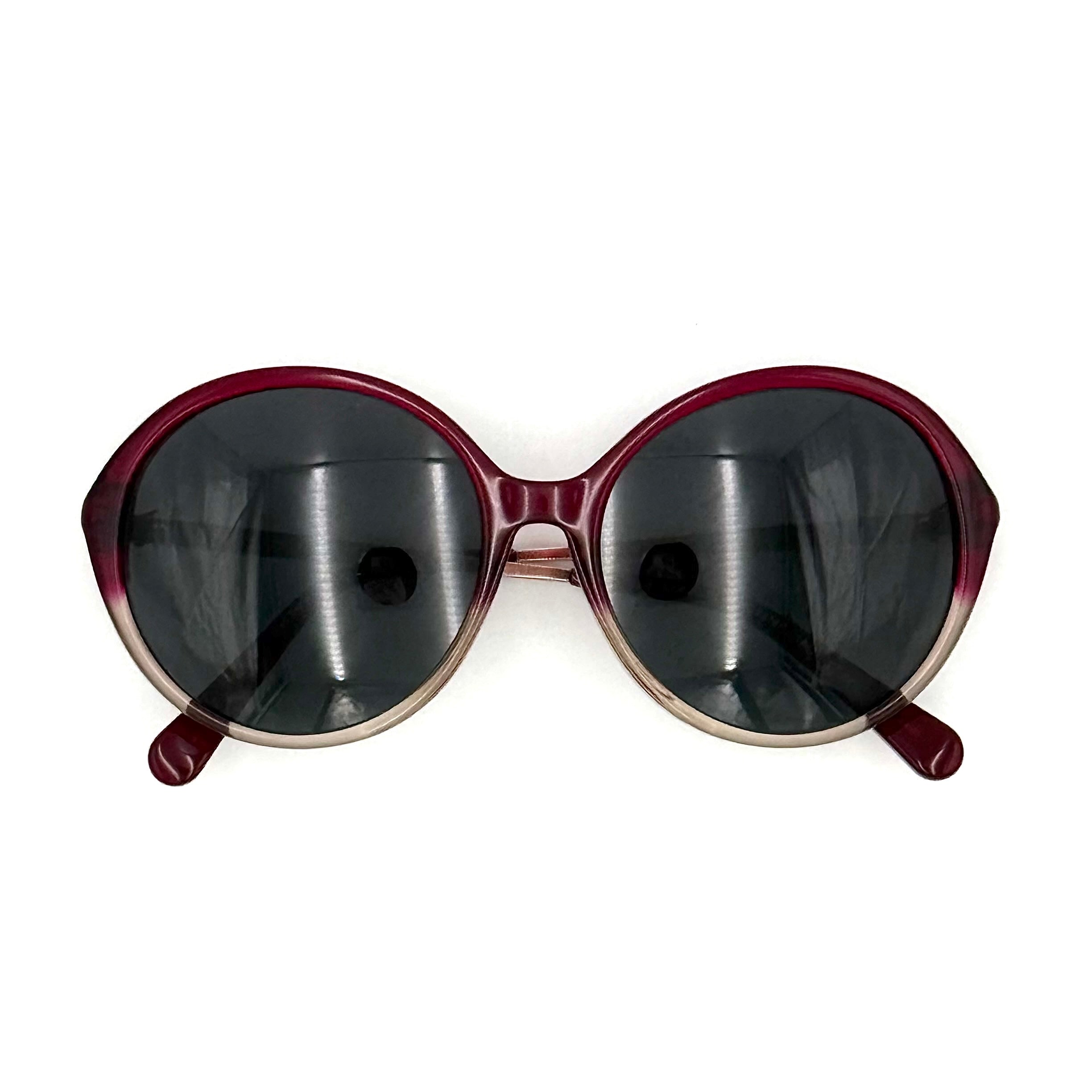 Coach HC8214F sunglasses in a red-to-sand gradient acetate frame with gold-tone metal temples and signature carriage detail.