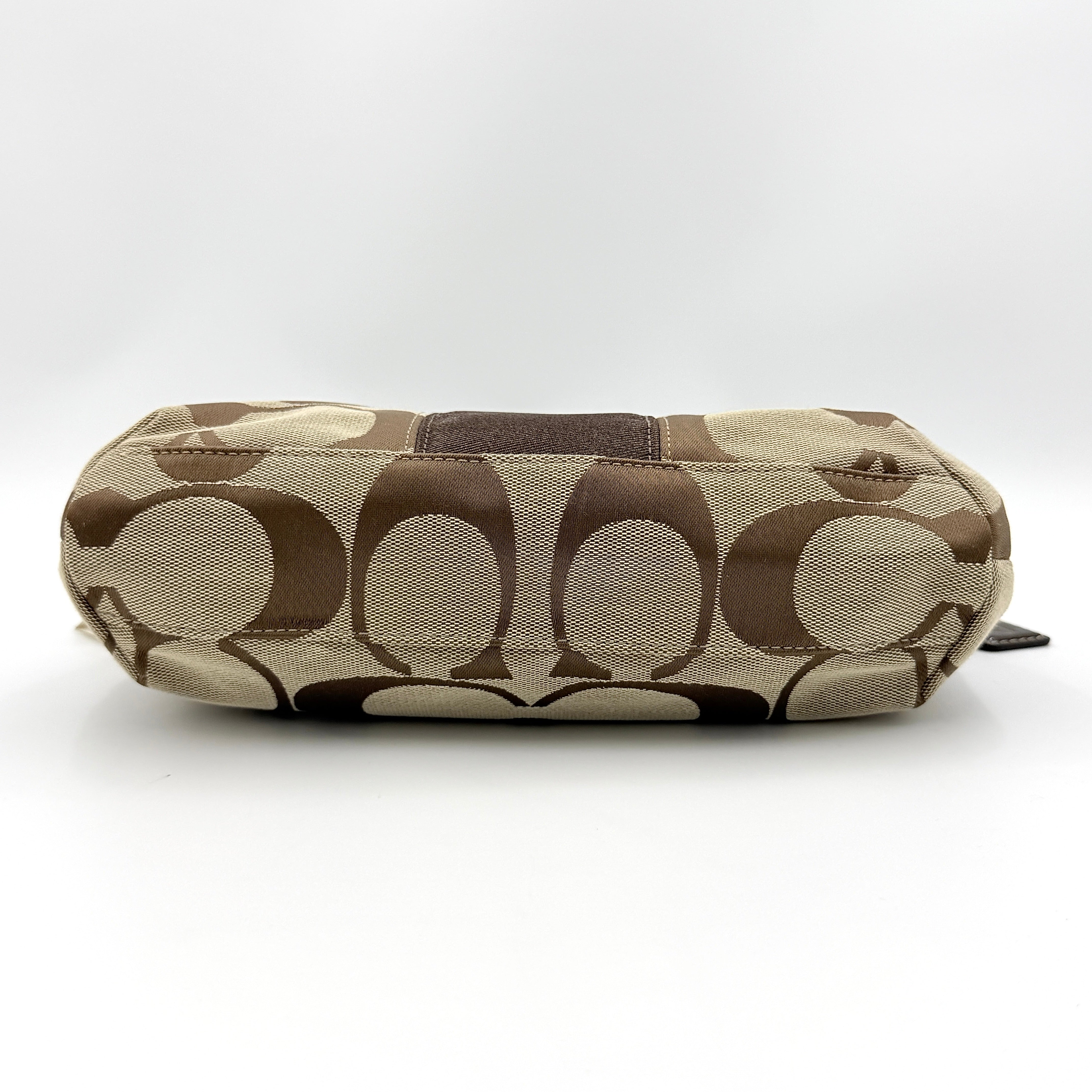 Coach khaki and mahogany signature jacquard shoulder bag with detachable strap and silver hardware displayed on a white background.