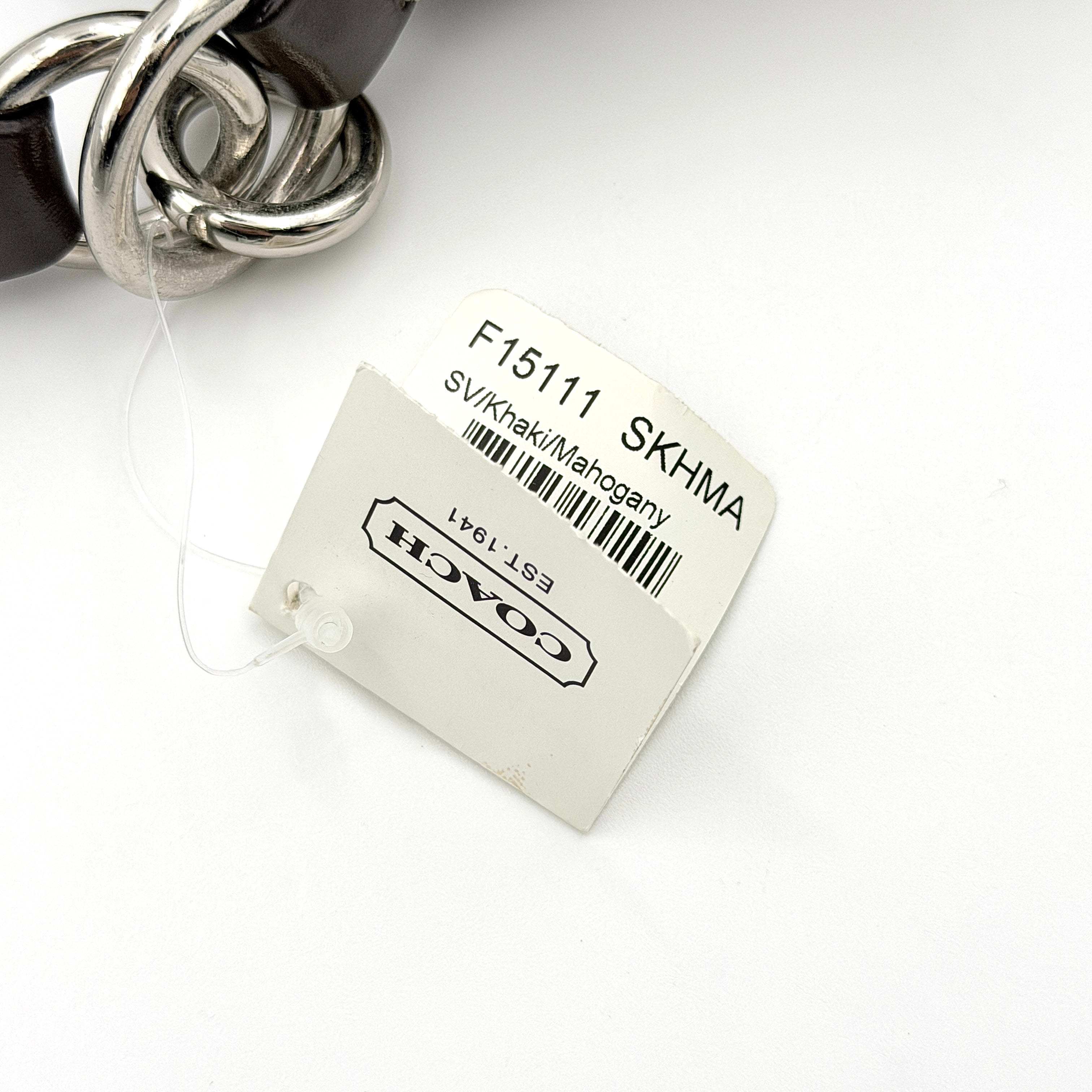 Coach khaki and mahogany signature jacquard shoulder bag with detachable strap and silver hardware displayed on a white background.