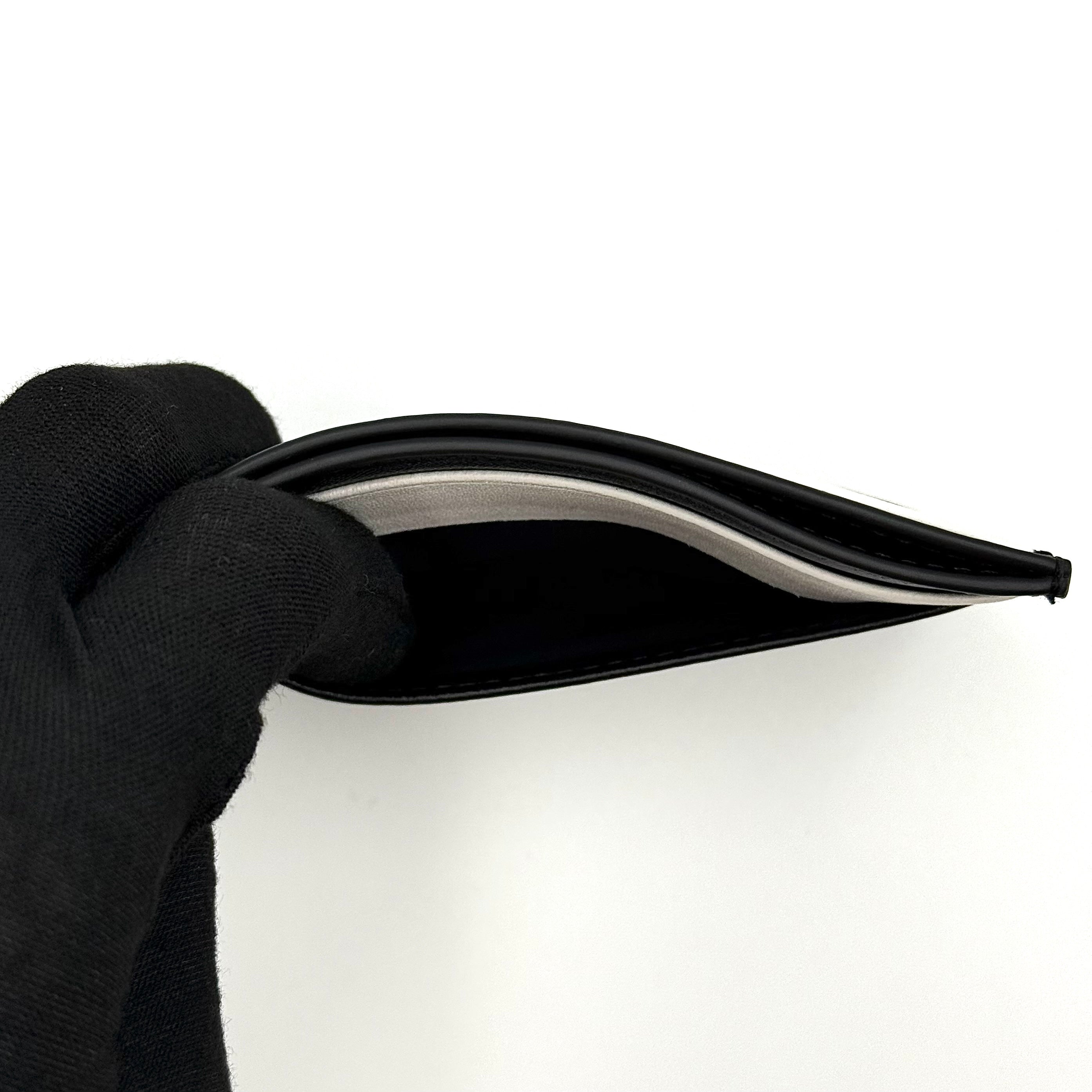 Furla WP00173 black leather cardholder with bold white logo and accent, shown against a white backdrop.