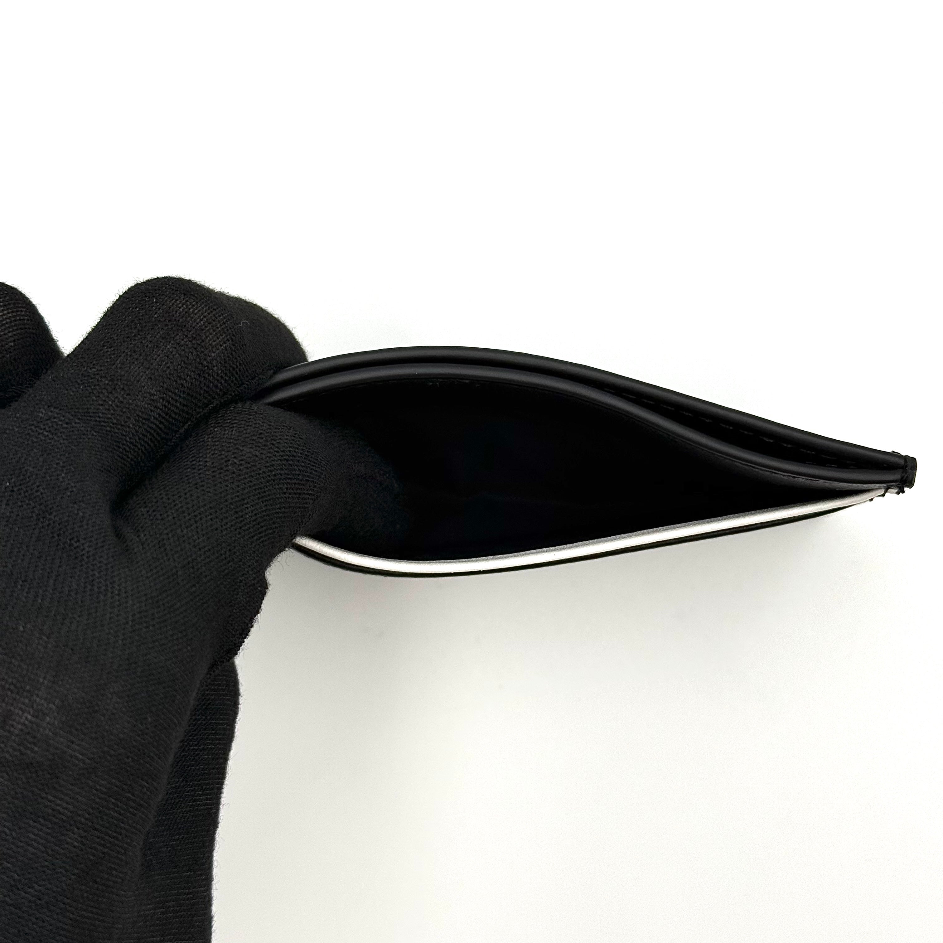 Furla WP00173 black leather cardholder with bold white logo and accent, shown against a white backdrop.