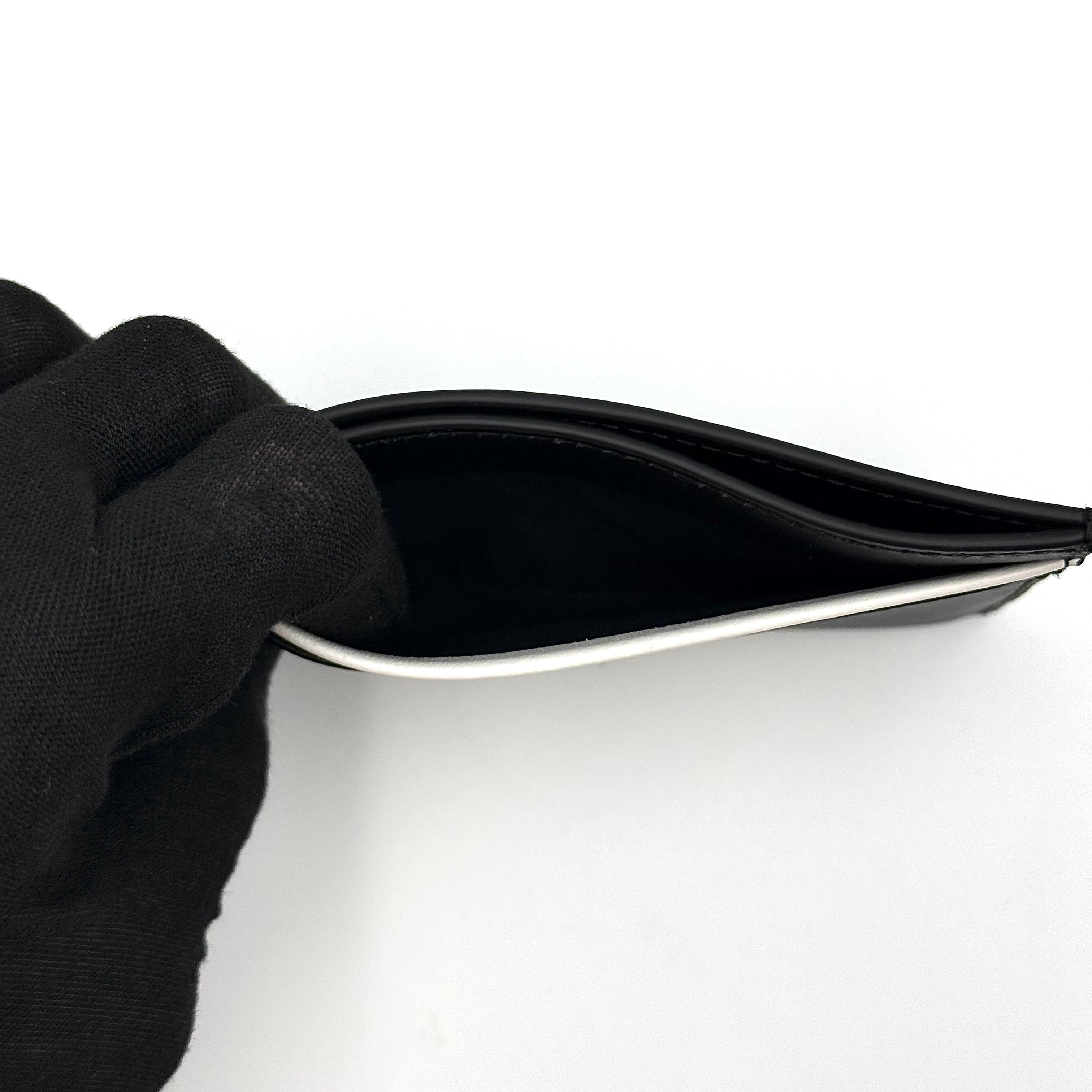 Furla WP00173 black leather cardholder with bold white logo and accent, shown against a white backdrop.