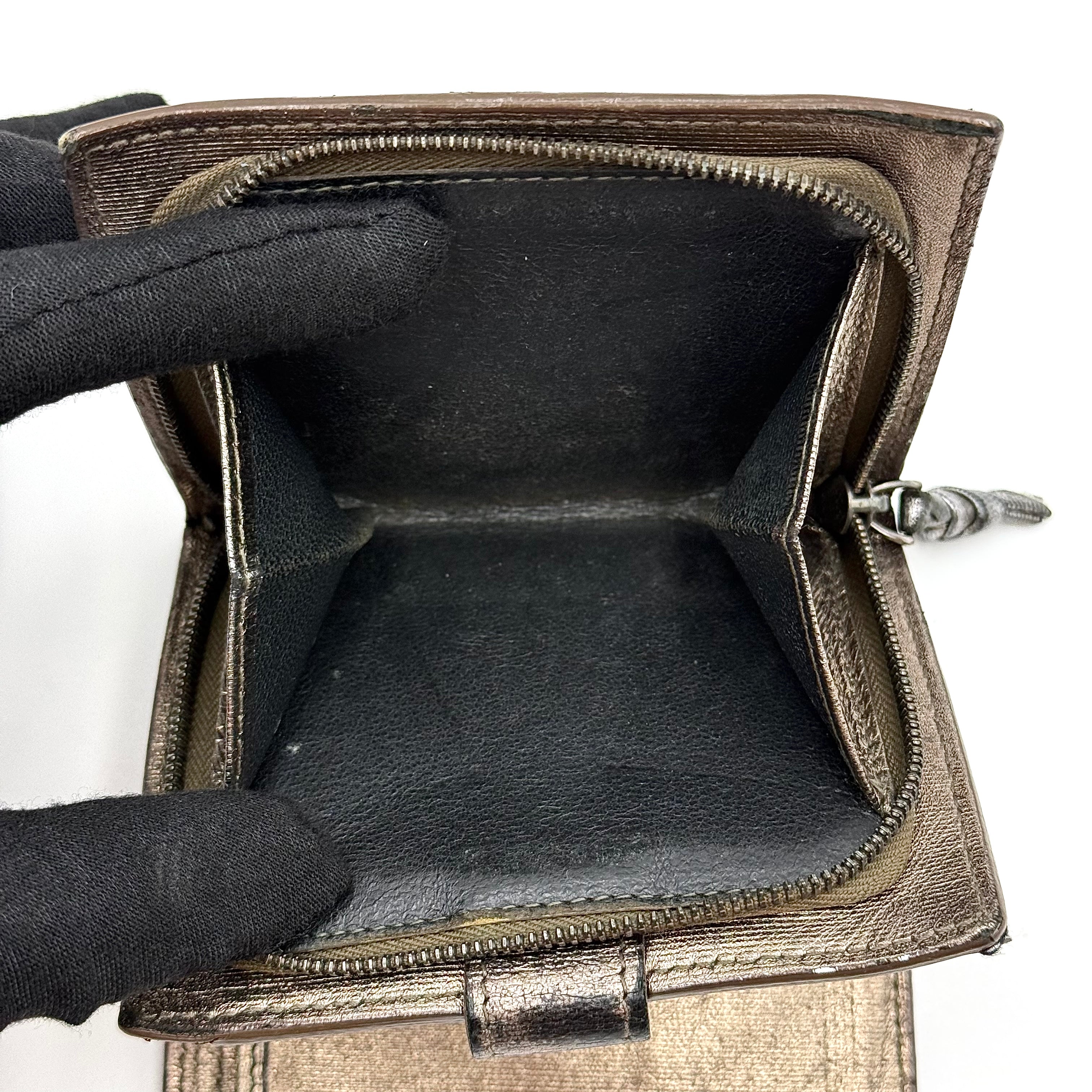 Bottega Veneta intrecciato metallic bronze leather wallet with snap tab and zip compartment.