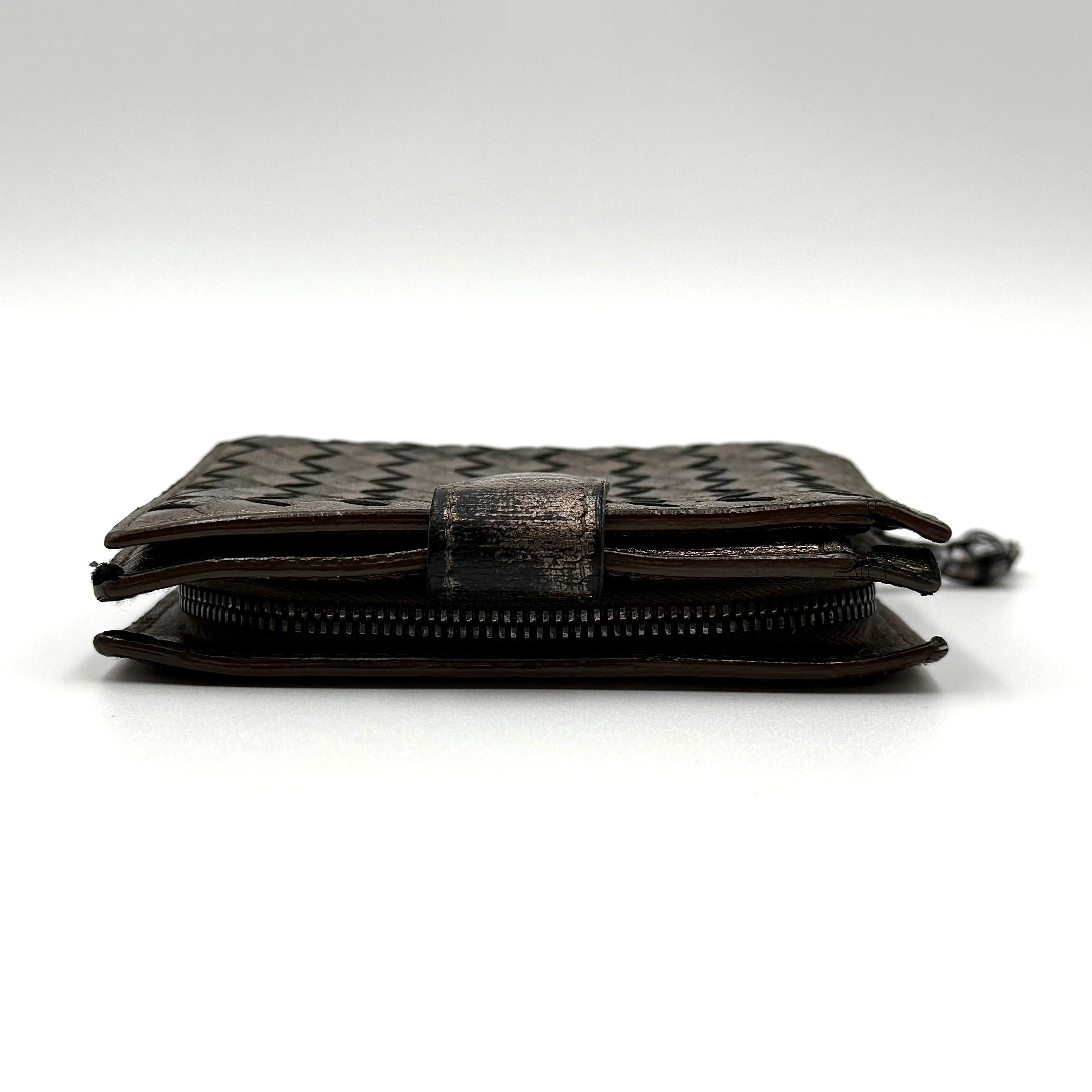 Bottega Veneta intrecciato metallic bronze leather wallet with snap tab and zip compartment.