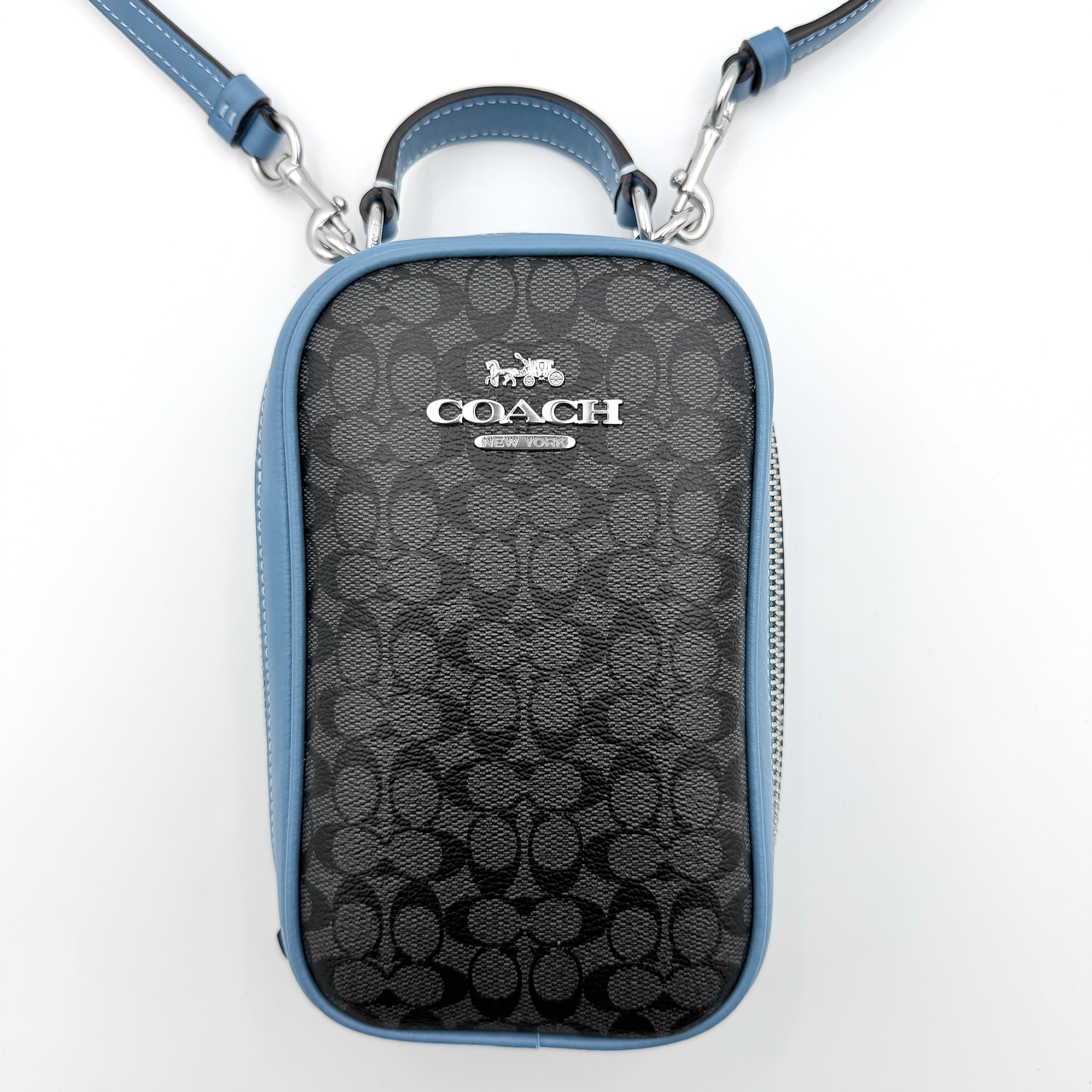 Coach Signature Eva Phone Crossbody in black coated canvas with blue leather trim and silver hardware displayed with its crossbody strap.