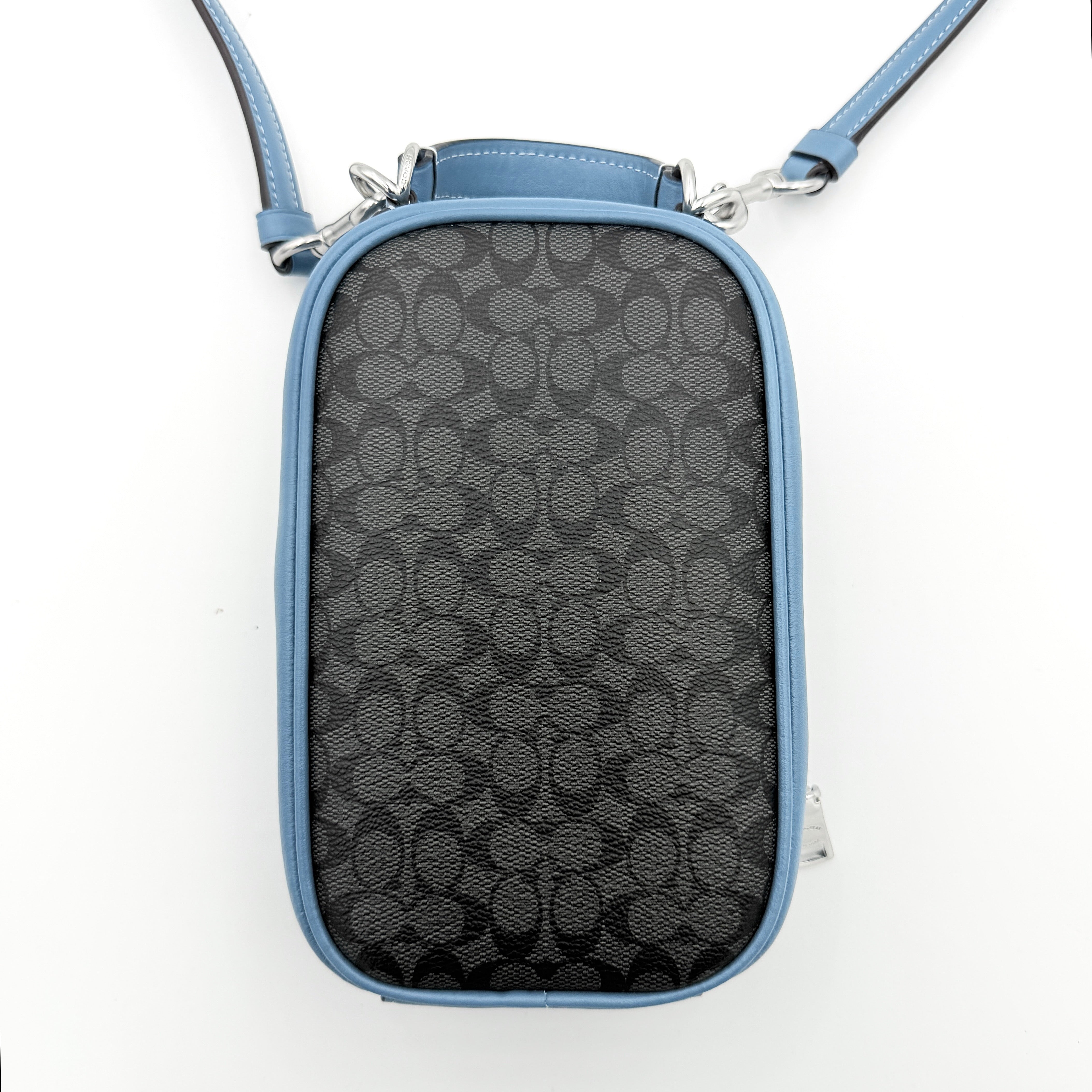 Coach Signature Eva Phone Crossbody in black coated canvas with blue leather trim and silver hardware displayed with its crossbody strap.