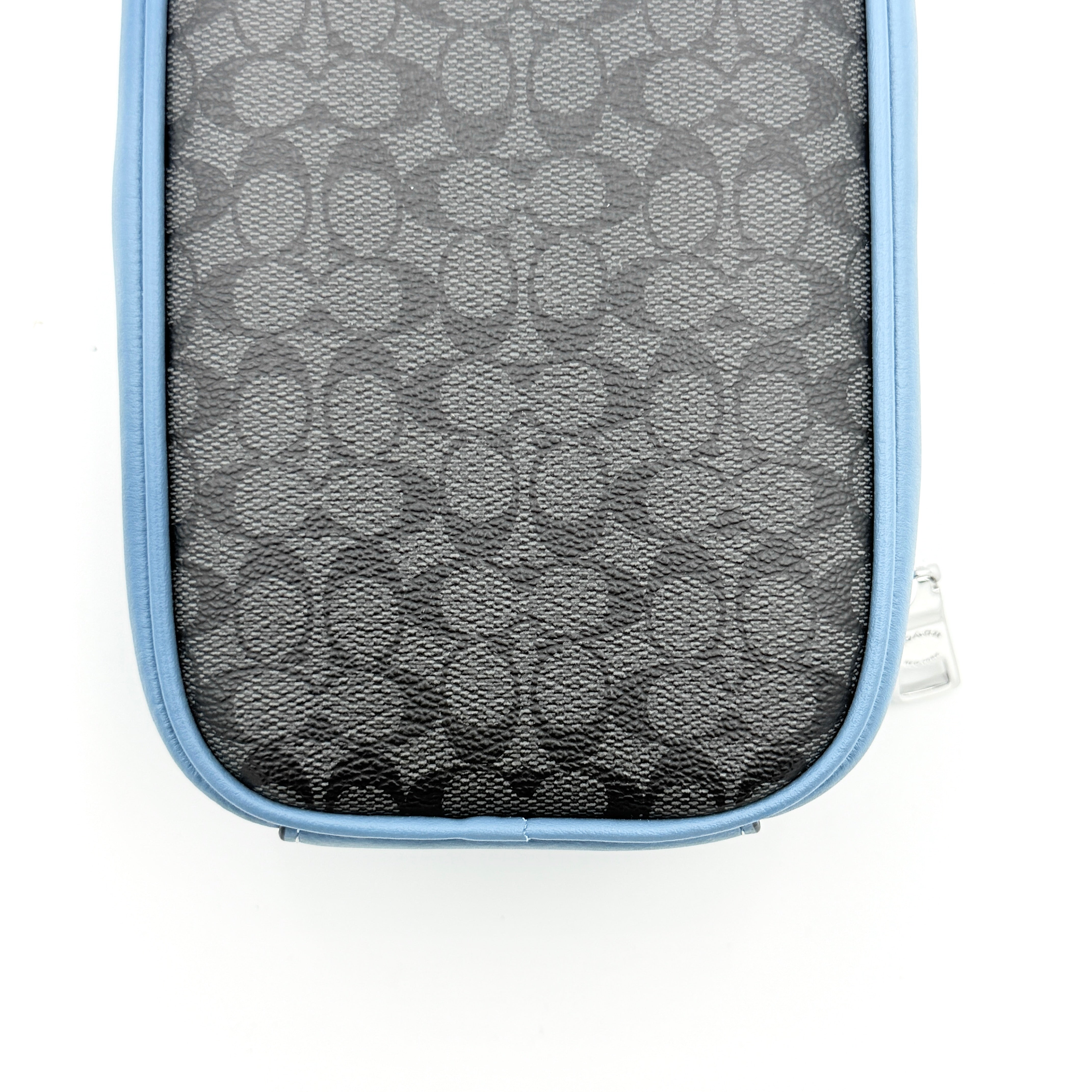 Coach Signature Eva Phone Crossbody in black coated canvas with blue leather trim and silver hardware displayed with its crossbody strap.