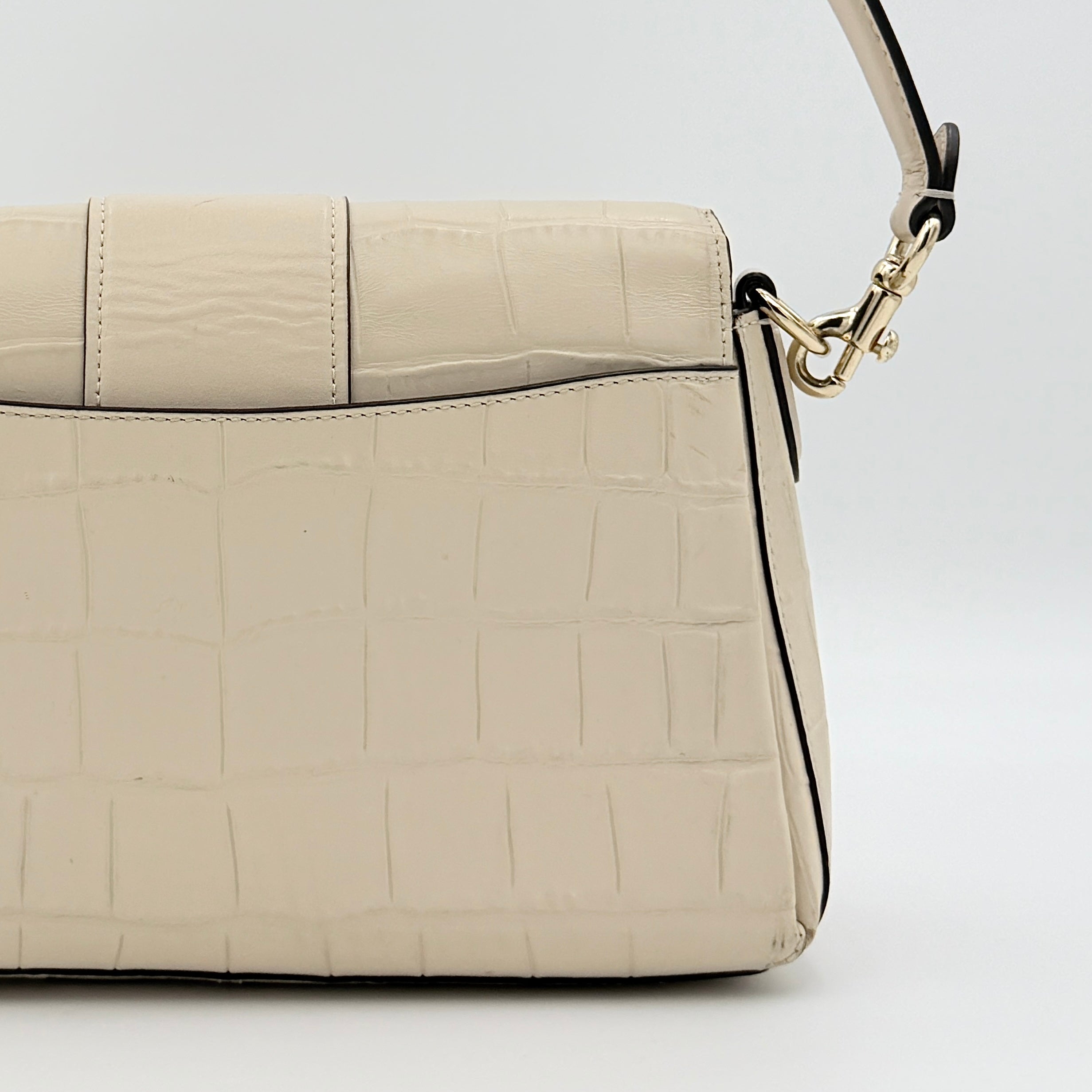Coach Grace Shoulder Bag in ivory croc-embossed leather with gold-tone carriage plaque and structured shoulder strap.