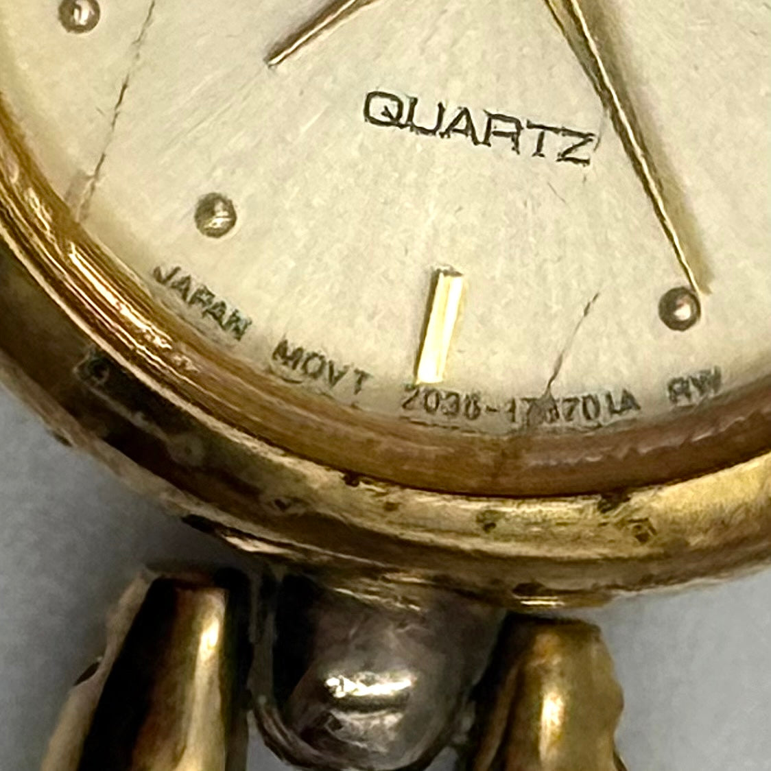 Citizen Free Way two-tone quartz watch with gold and silver link bracelet displayed on a black cushion.
