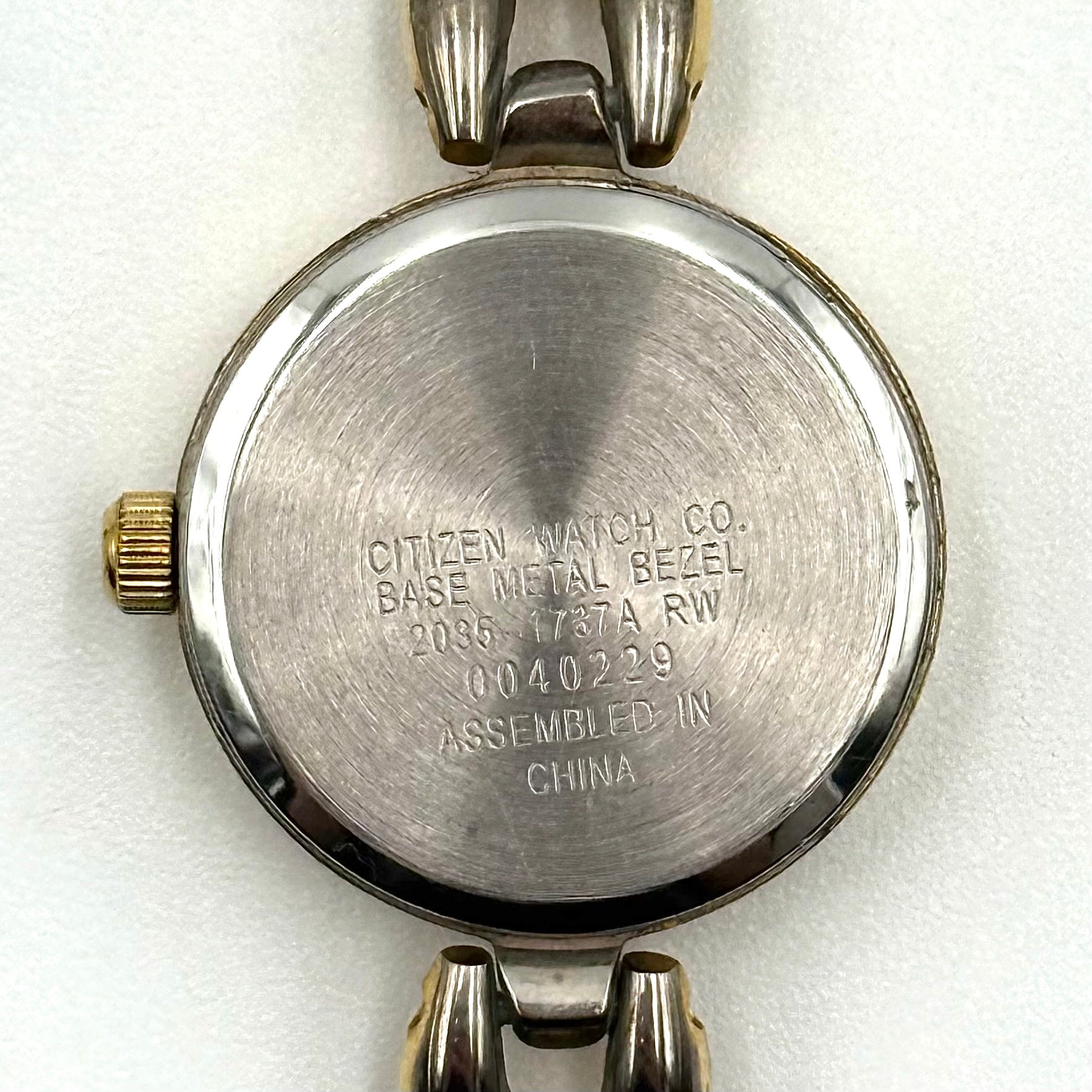 Citizen Free Way two-tone quartz watch with gold and silver link bracelet displayed on a black cushion.