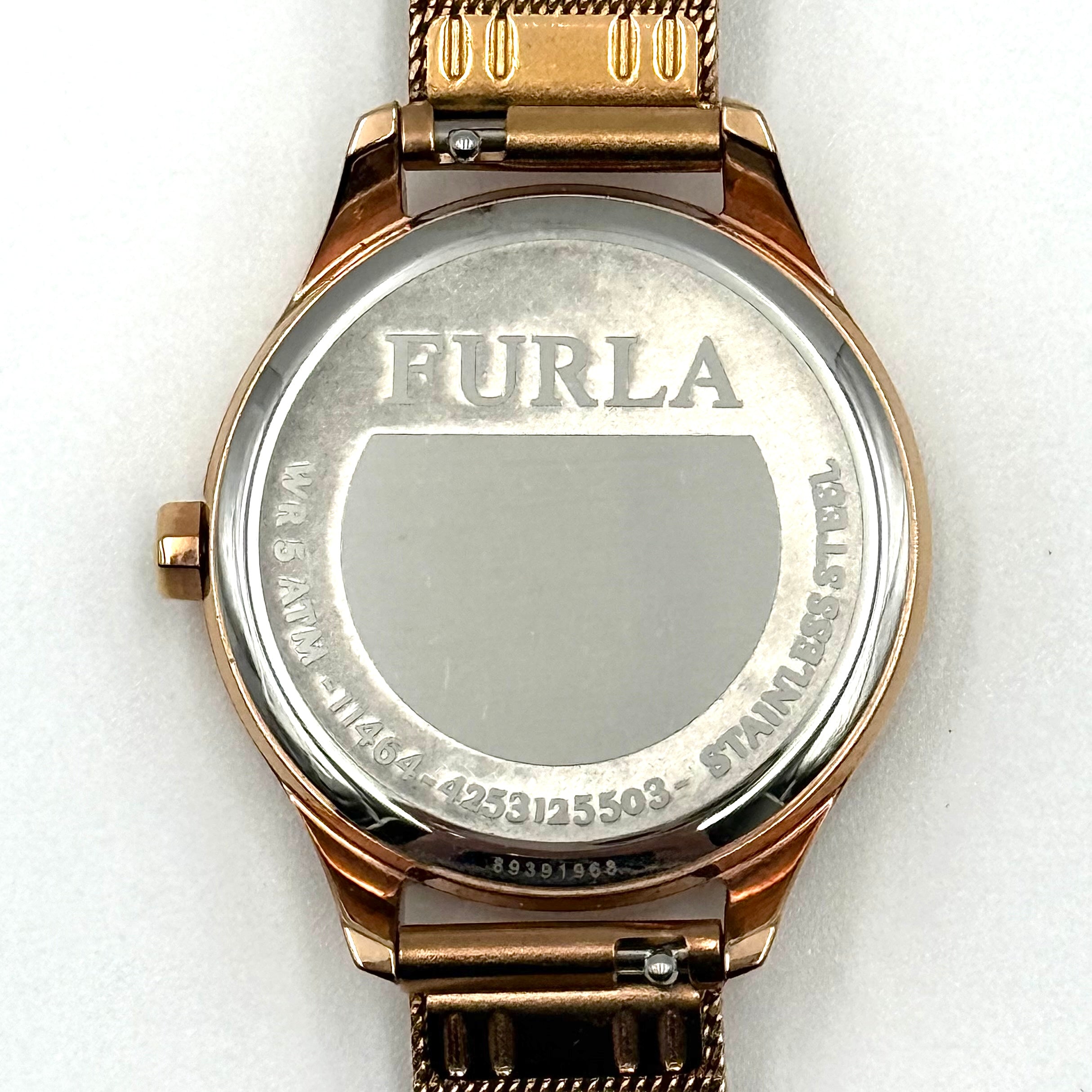 Furla WR 5 ATM watch with pink dial and rose gold Milanese mesh strap displayed on a black cushion.