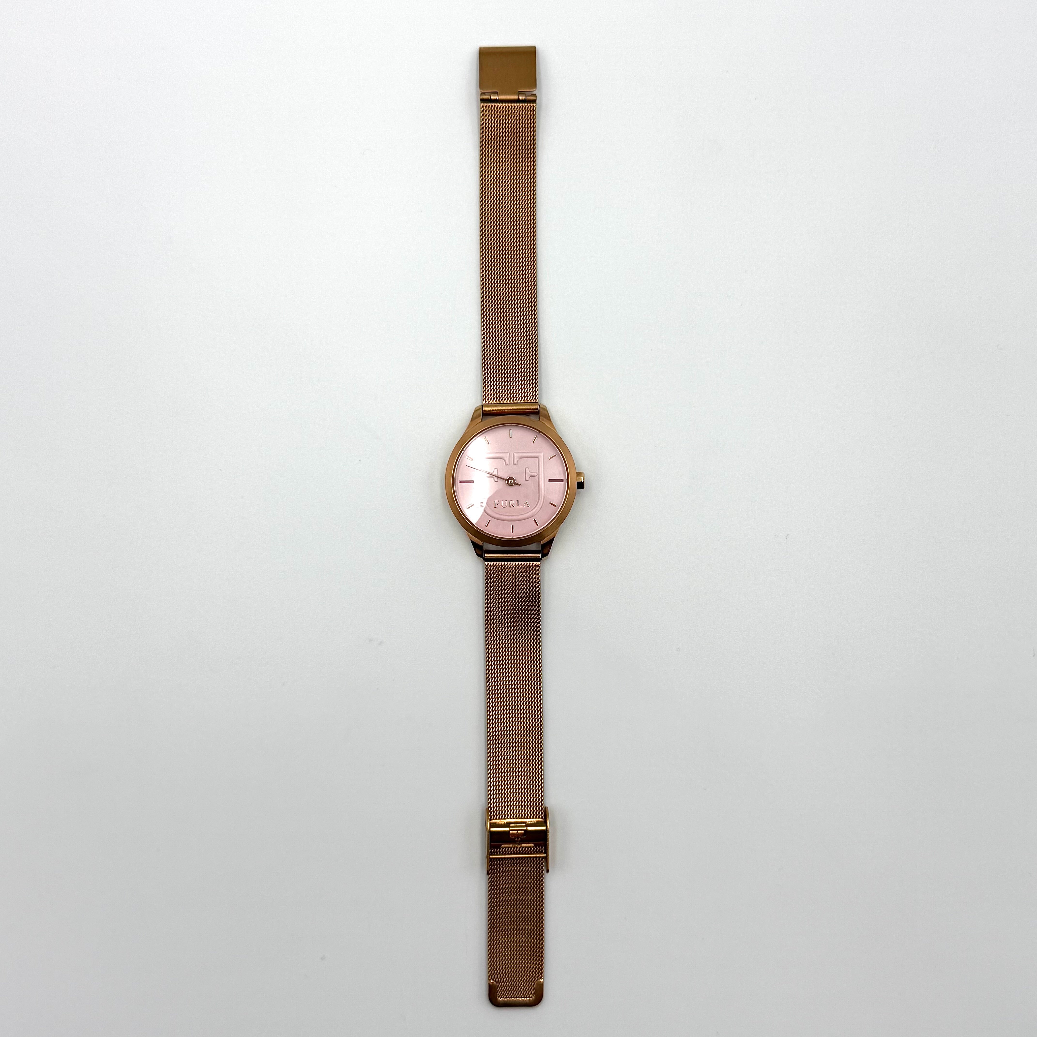 Furla WR 5 ATM watch with pink dial and rose gold Milanese mesh strap displayed on a black cushion.