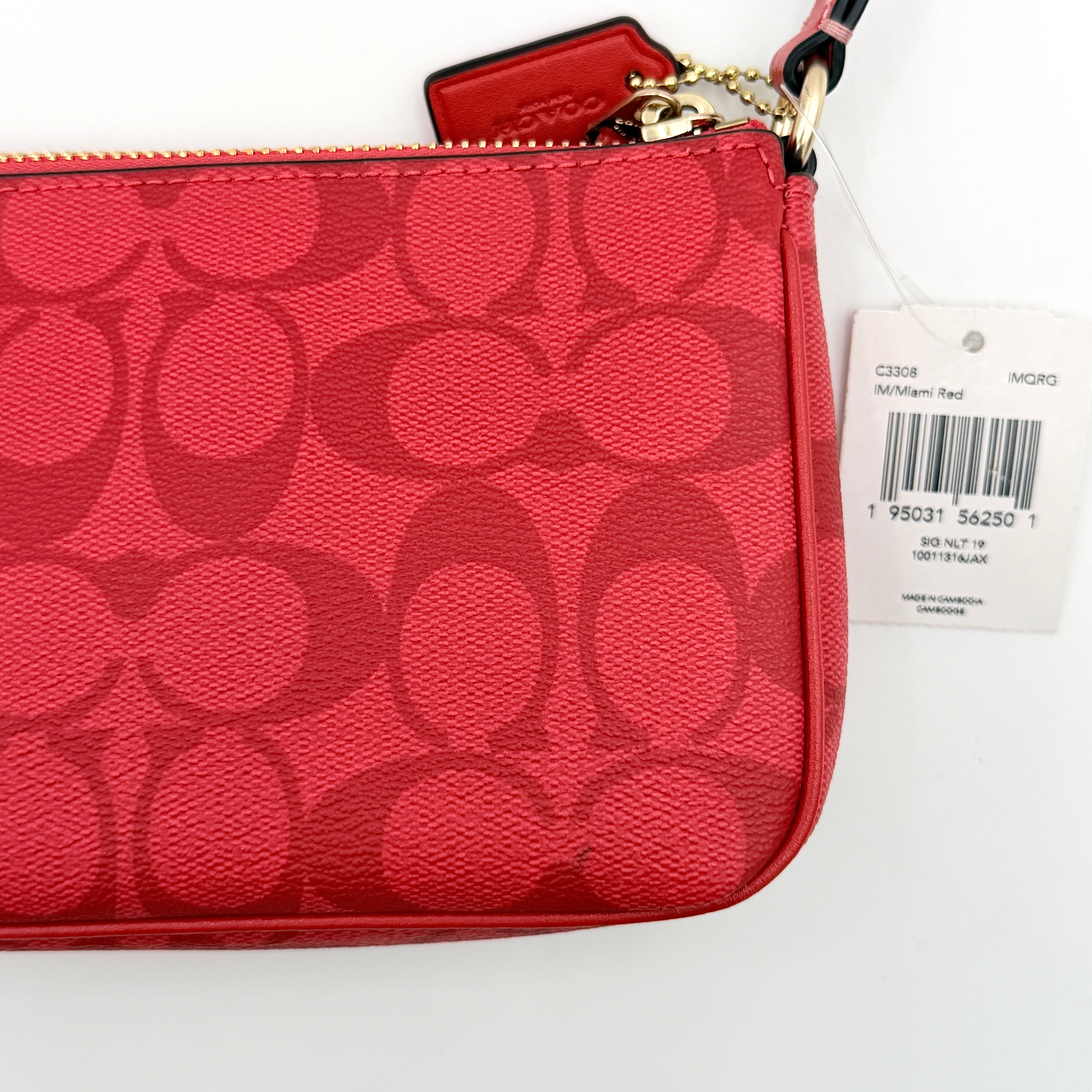 Coach Signature Nolita 19 Shoulder Bag in bright red coated canvas with signature pattern, gold-tone hardware and matching red hangtag.