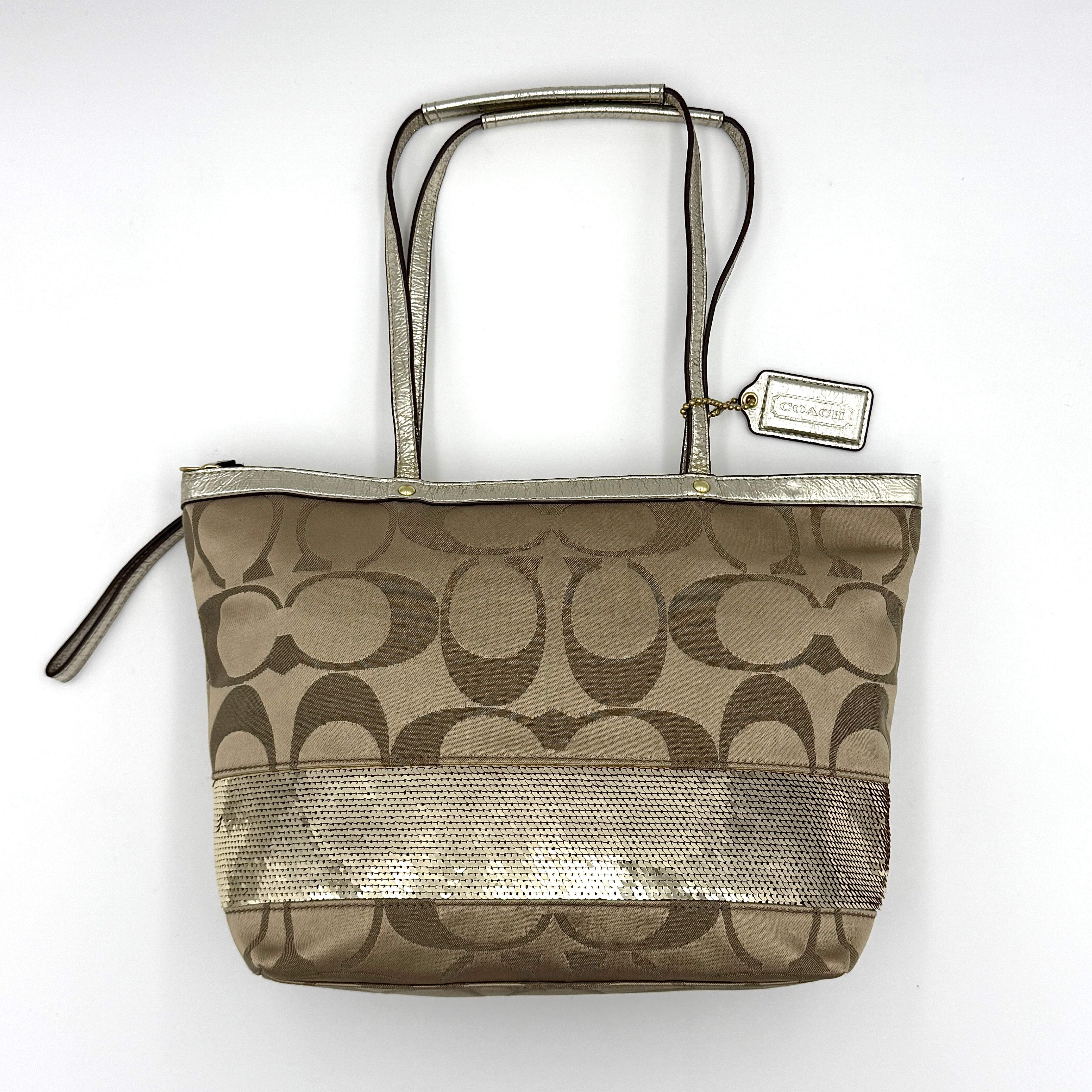 Coach Signature Stripe Tote Bag in gold and beige canvas with metallic gold leather trim and double handles.