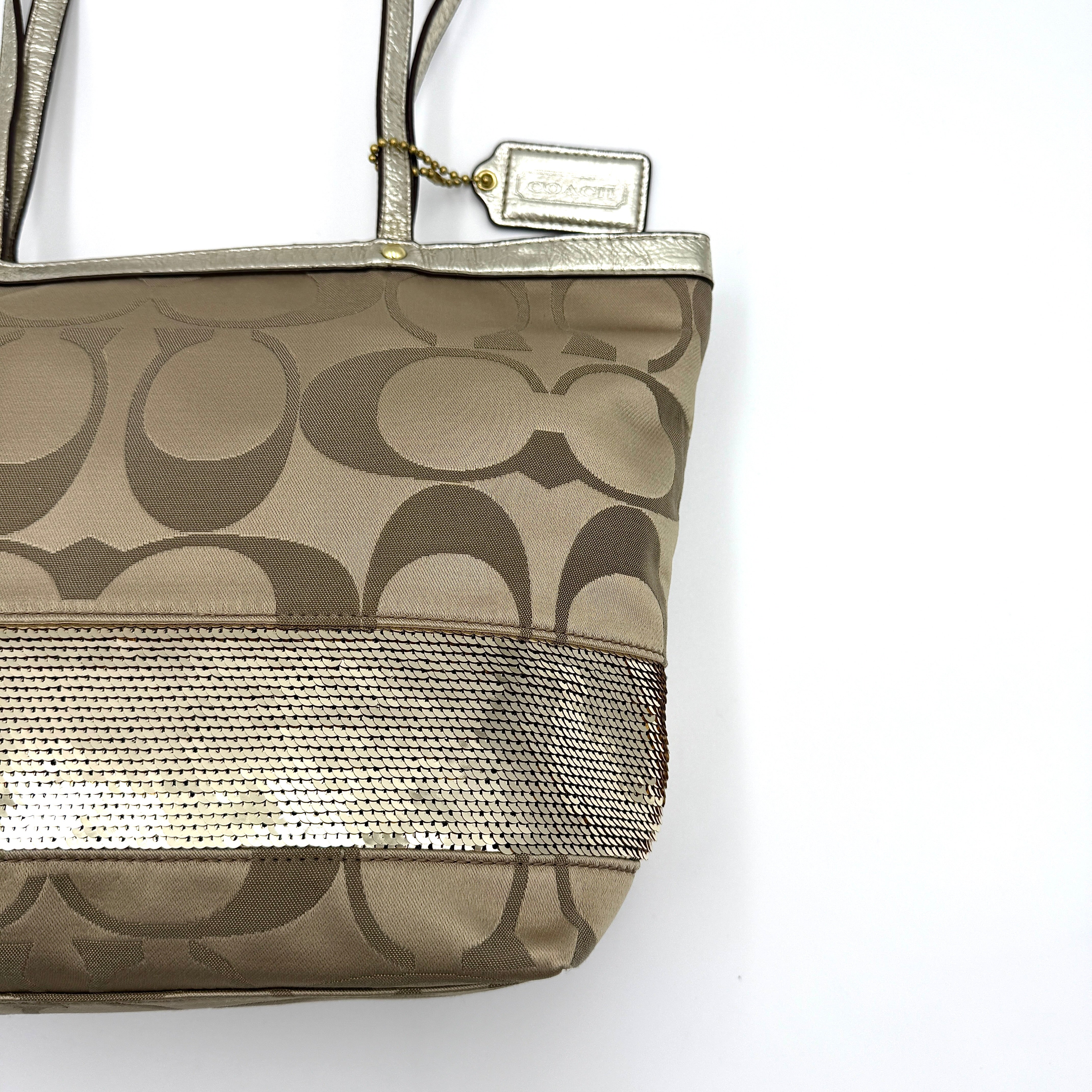 Coach Signature Stripe Tote Bag in gold and beige canvas with metallic gold leather trim and double handles.