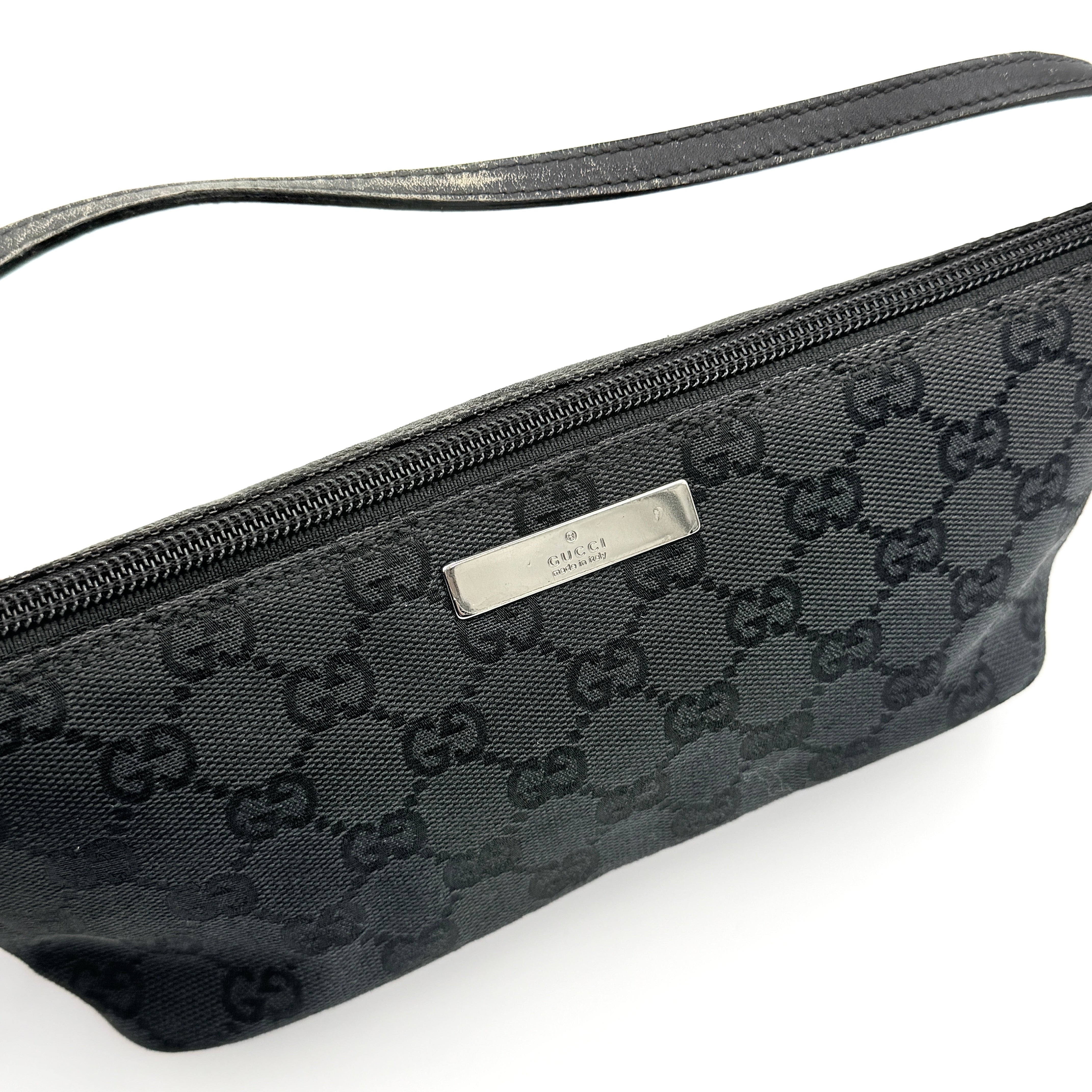 The Gucci GG Monogram Pochette Boat Shoulder Bag in black canvas with leather trim and silver-tone hardware, shown from the front with its structured, compact shape.