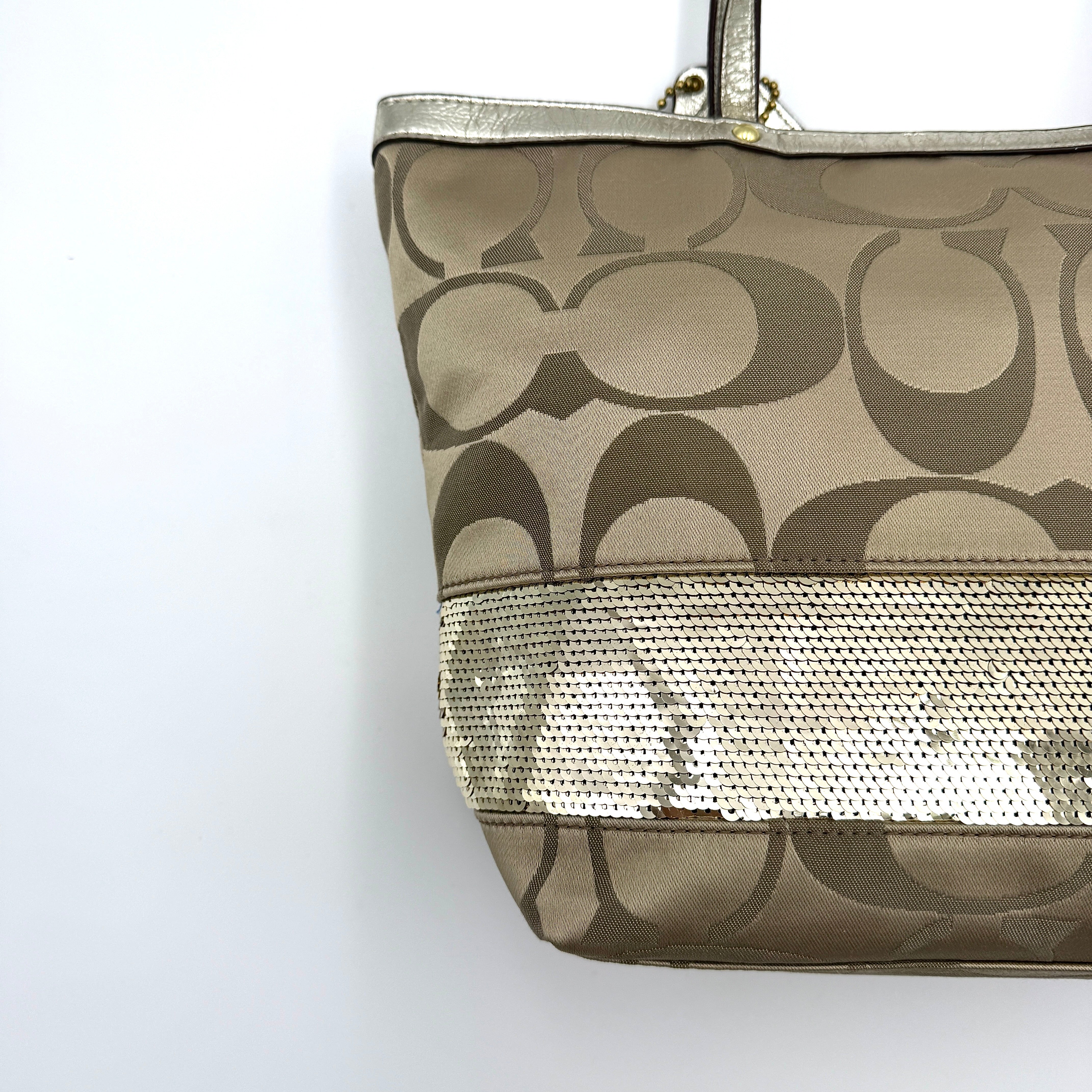 Coach Signature Stripe Tote Bag in gold and beige canvas with metallic gold leather trim and double handles.