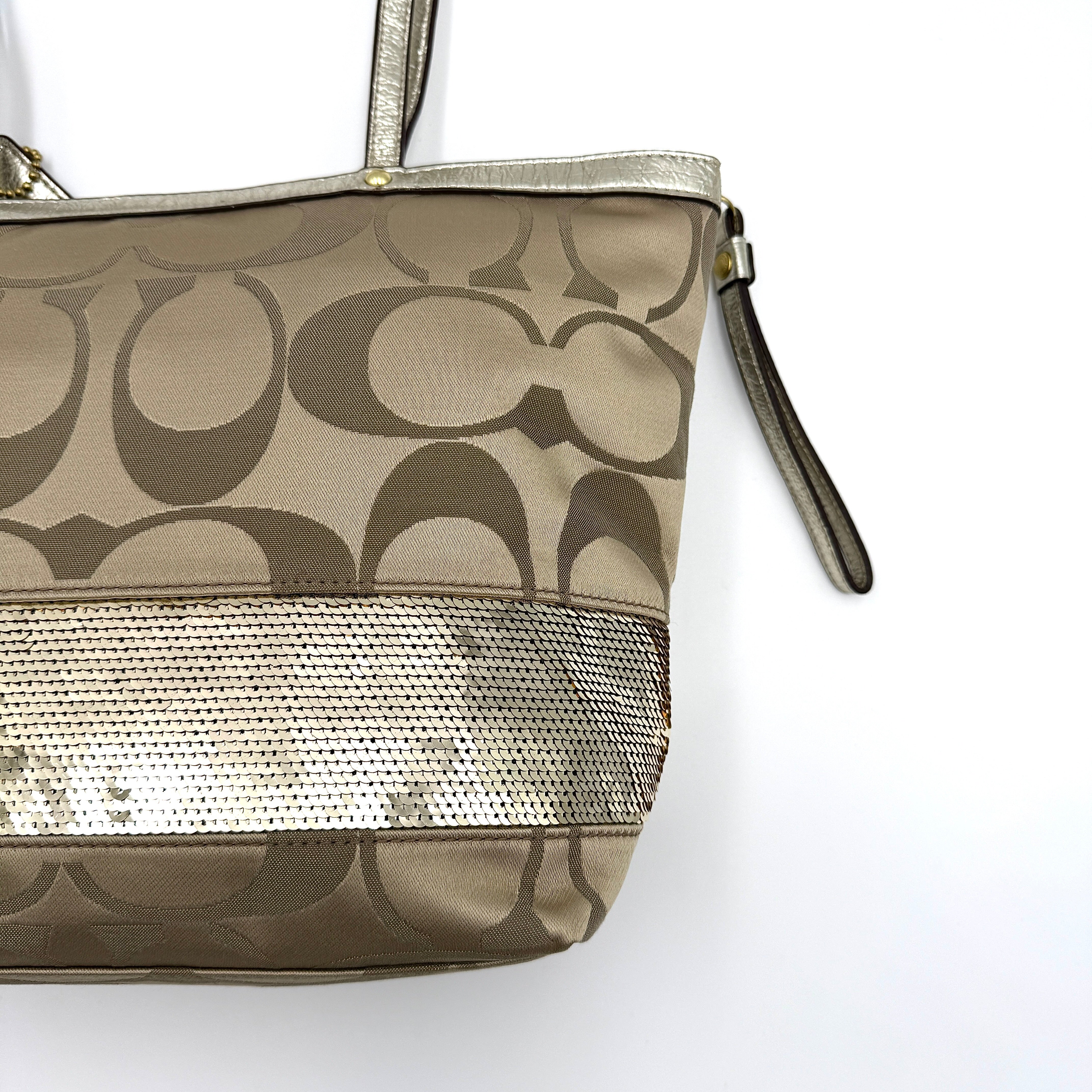 Coach Signature Stripe Tote Bag in gold and beige canvas with metallic gold leather trim and double handles.