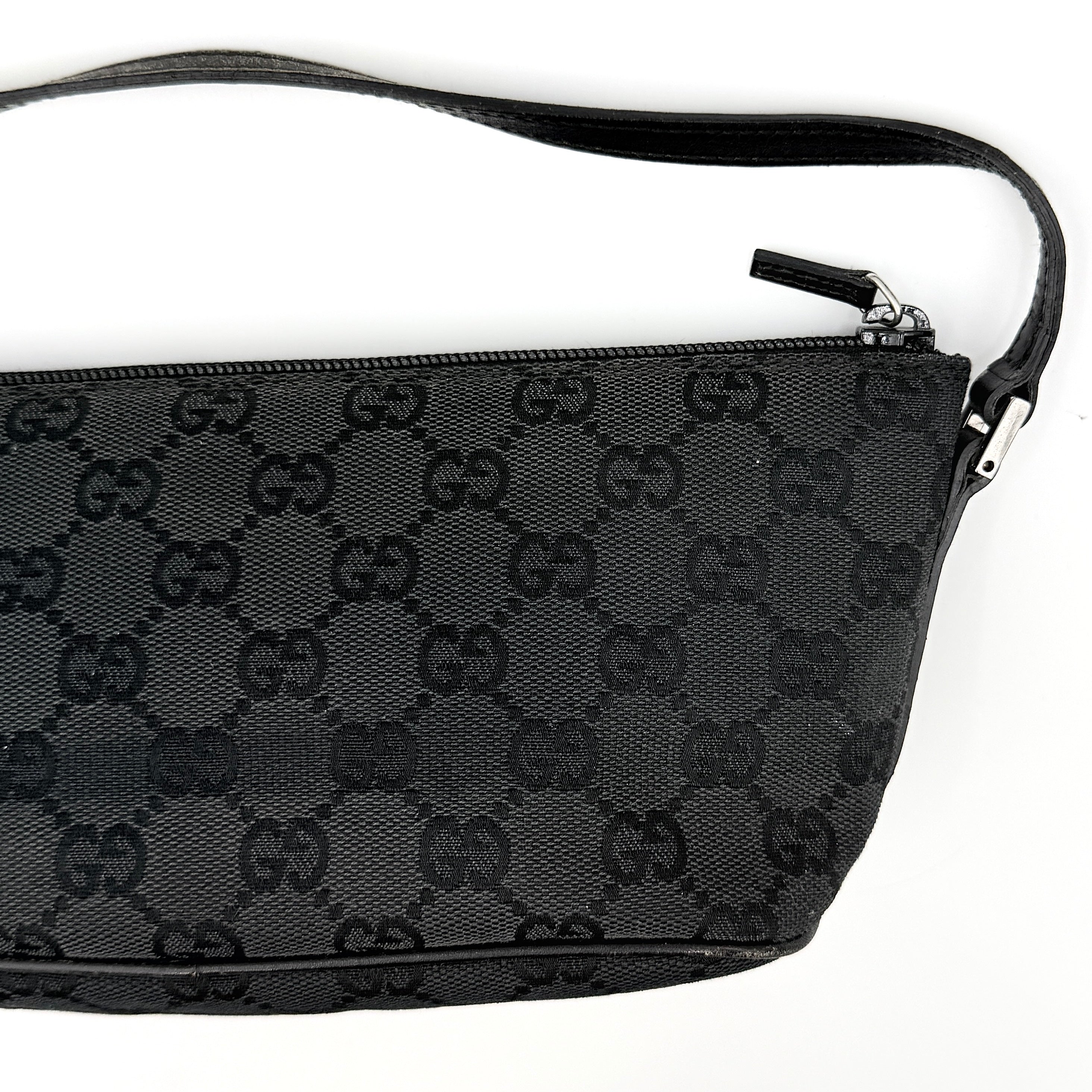 The Gucci GG Monogram Pochette Boat Shoulder Bag in black canvas with leather trim and silver-tone hardware, shown from the front with its structured, compact shape.