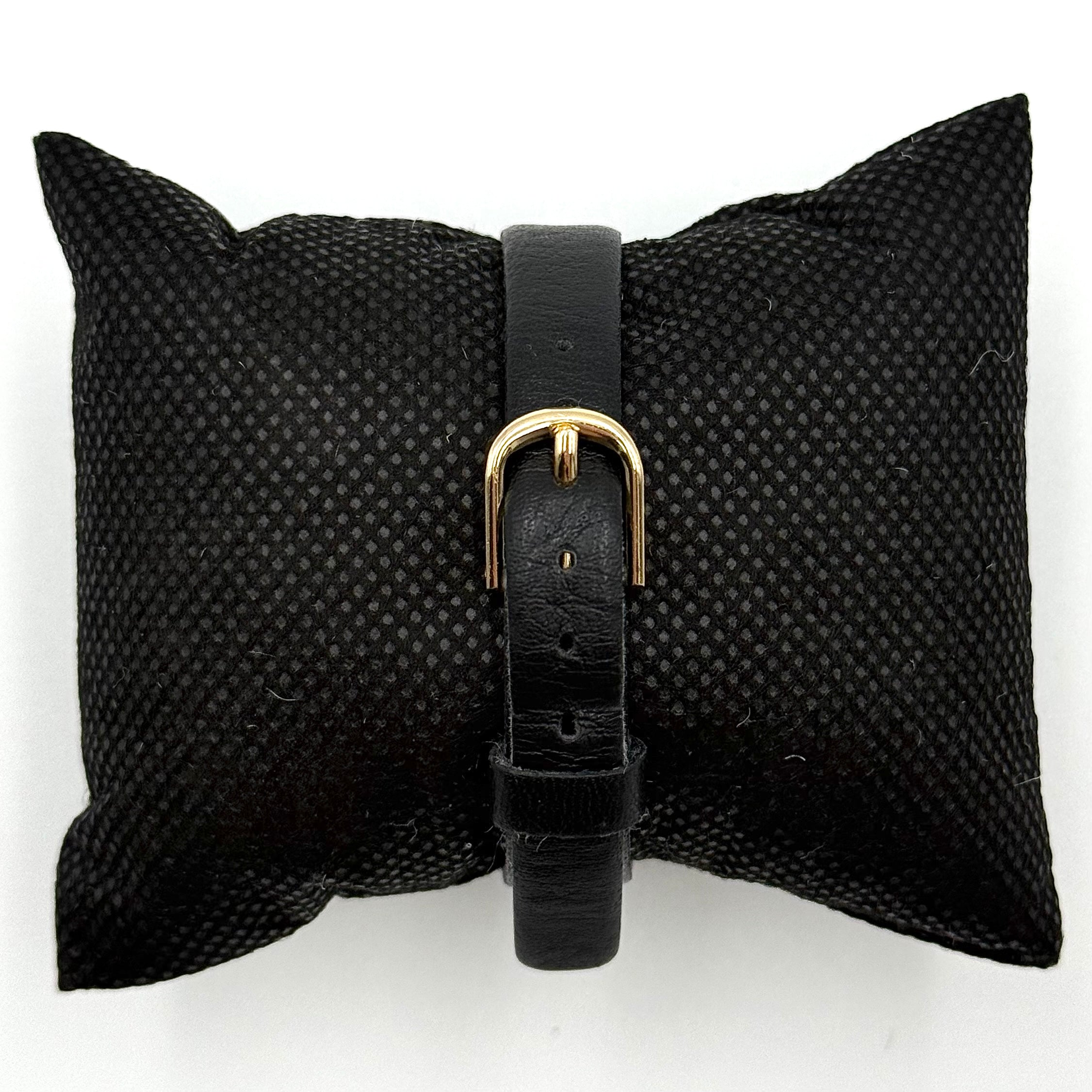 Citizen Castalia gold-tone square quartz watch with a champagne dial and black leather strap displayed on a black cushion.