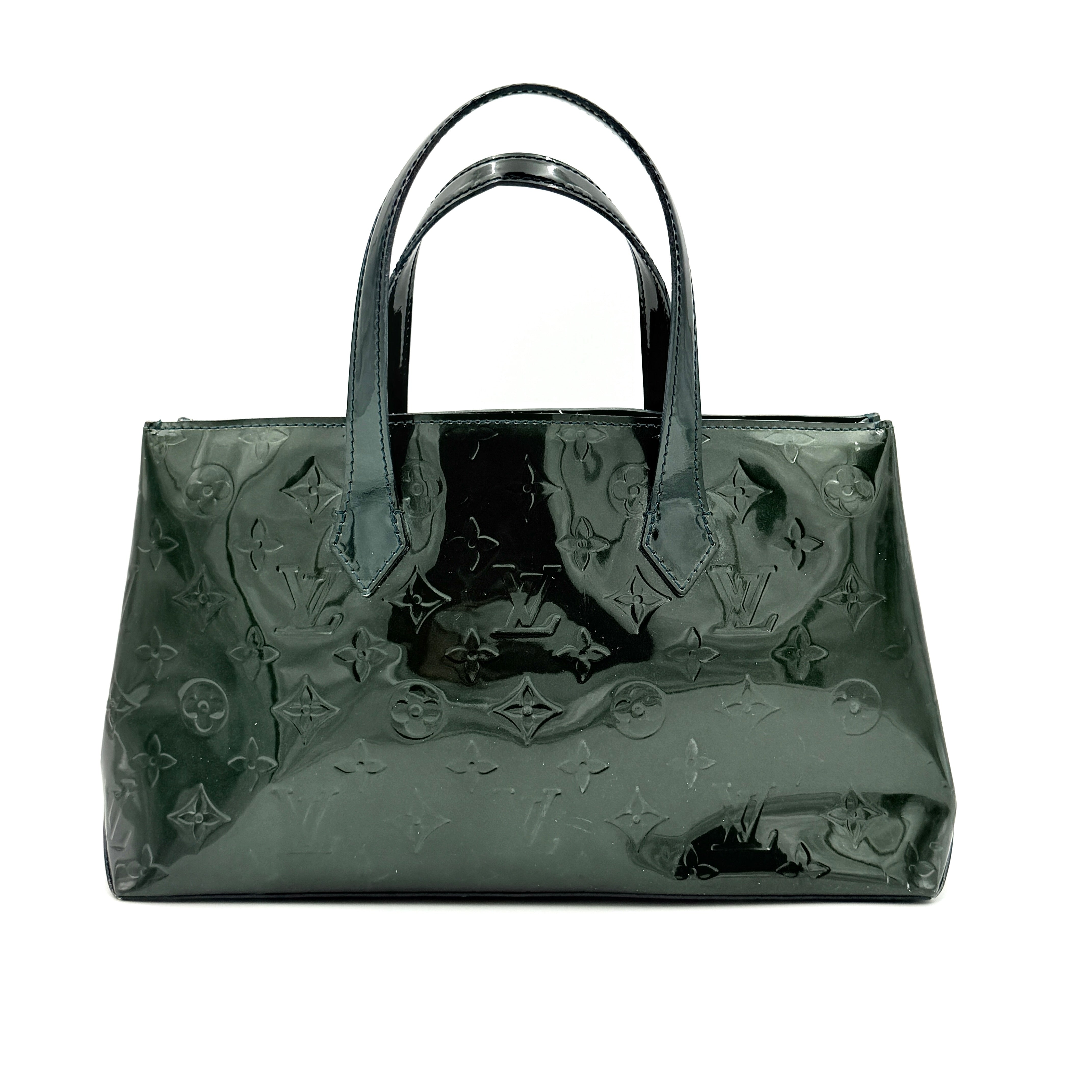 Louis Vuitton Wilshire PM bag in glossy dark green Monogram Vernis patent leather, shown with double top handles and gold-tone nameplate.