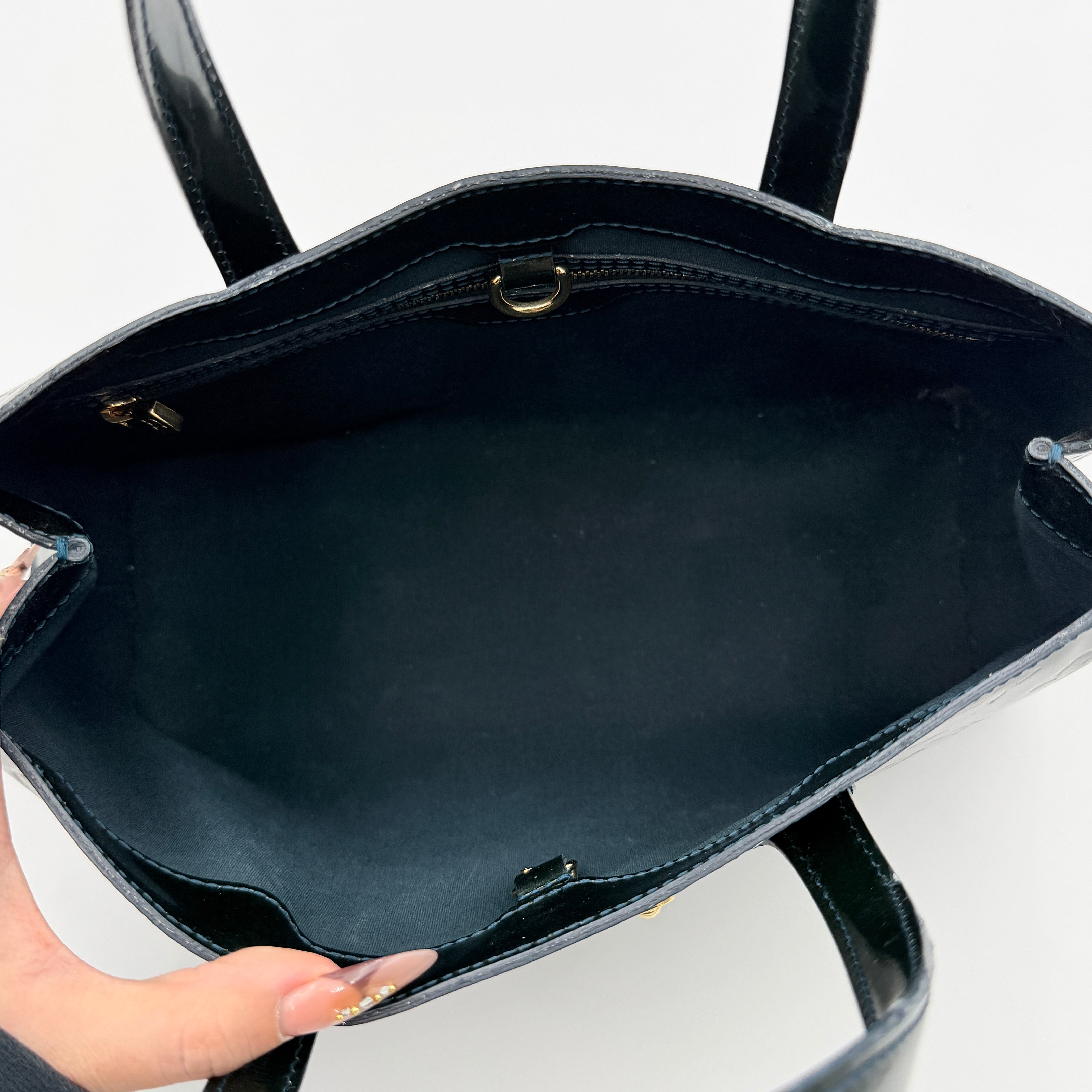 Louis Vuitton Wilshire PM bag in glossy dark green Monogram Vernis patent leather, shown with double top handles and gold-tone nameplate.