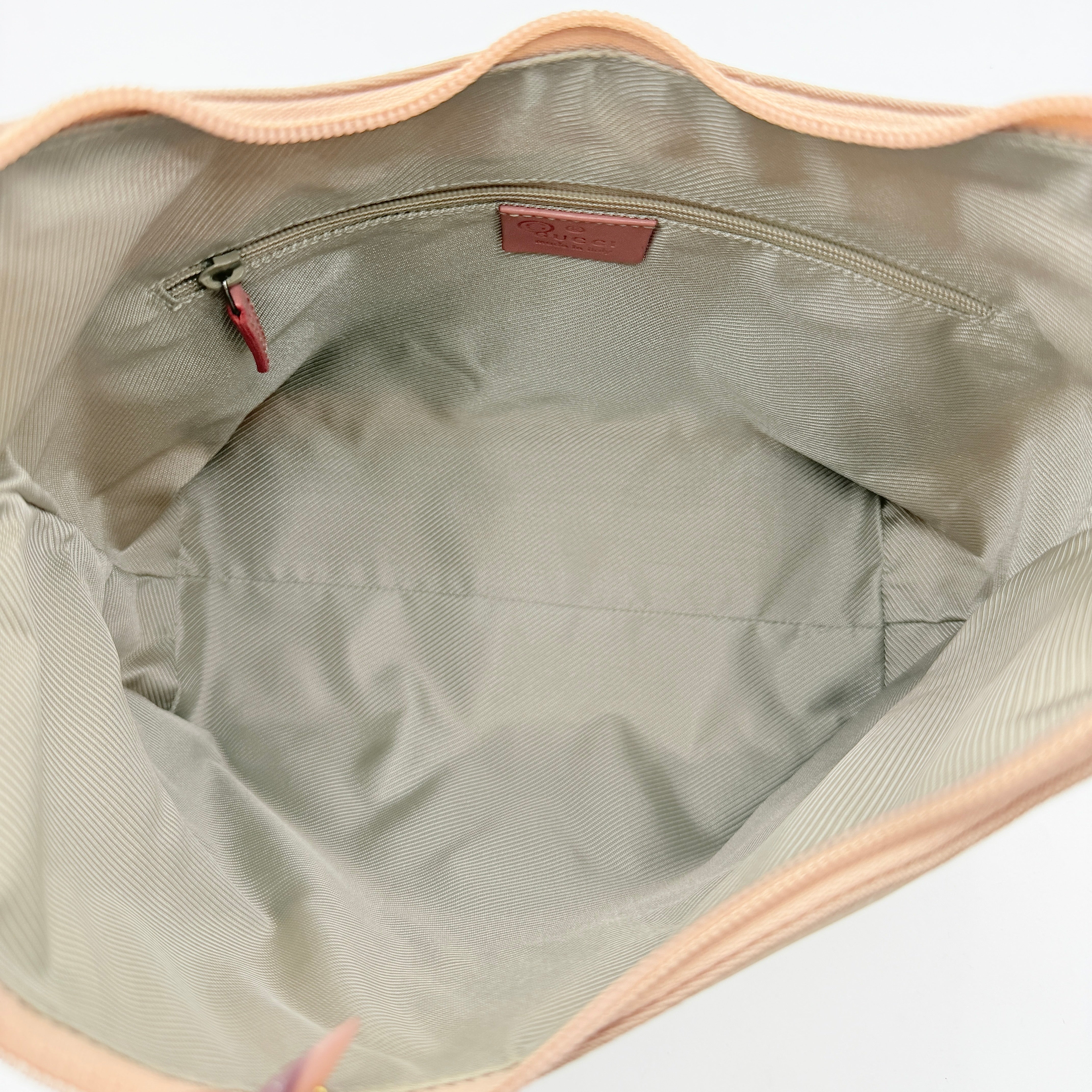 Gucci beige canvas hobo shoulder bag with pink leather accents and silver-tone hardware, displayed front-facing on a white background.