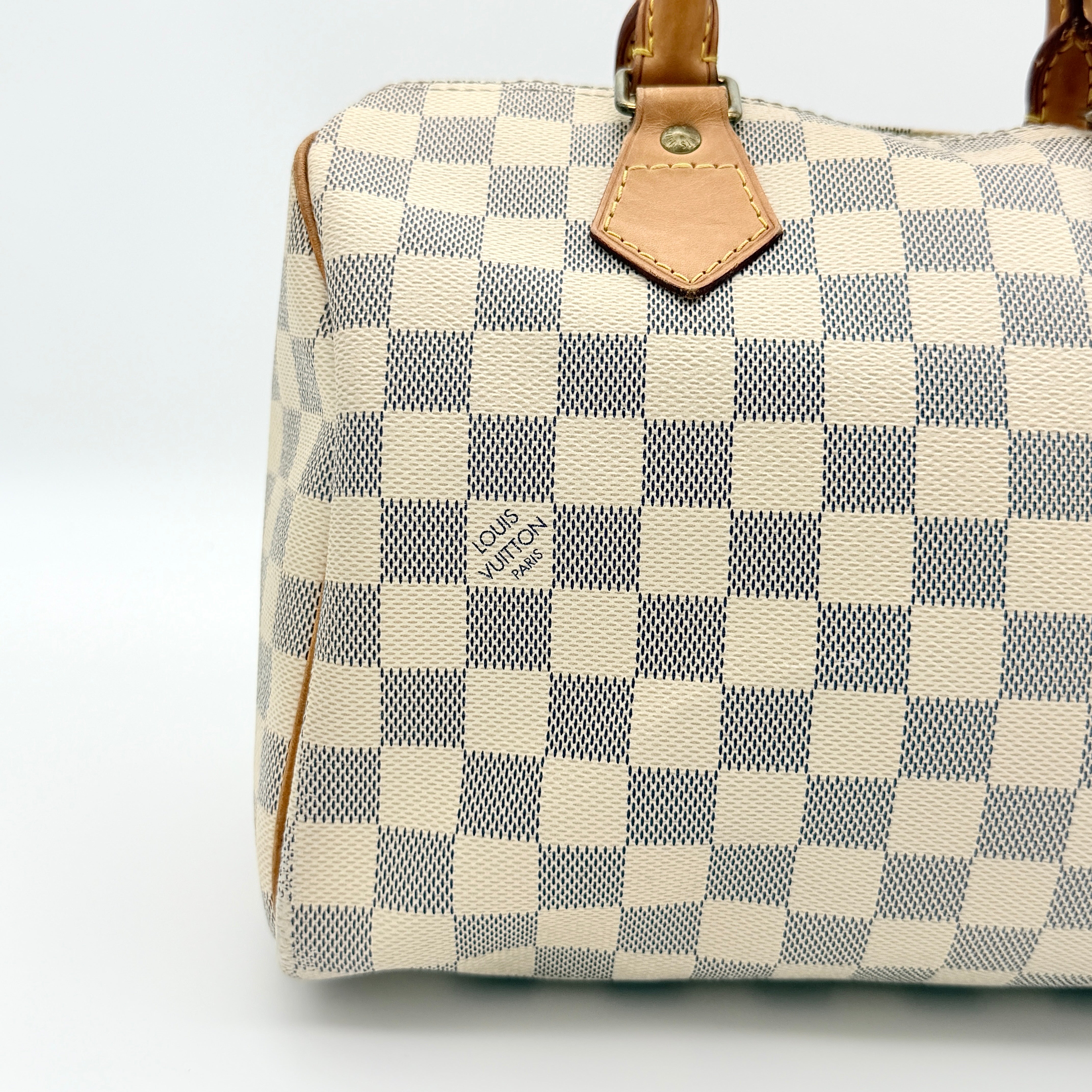 Louis Vuitton Damier Azur Speedy 25 handbag with natural leather handles, brass hardware, and included LV padlock and keys.