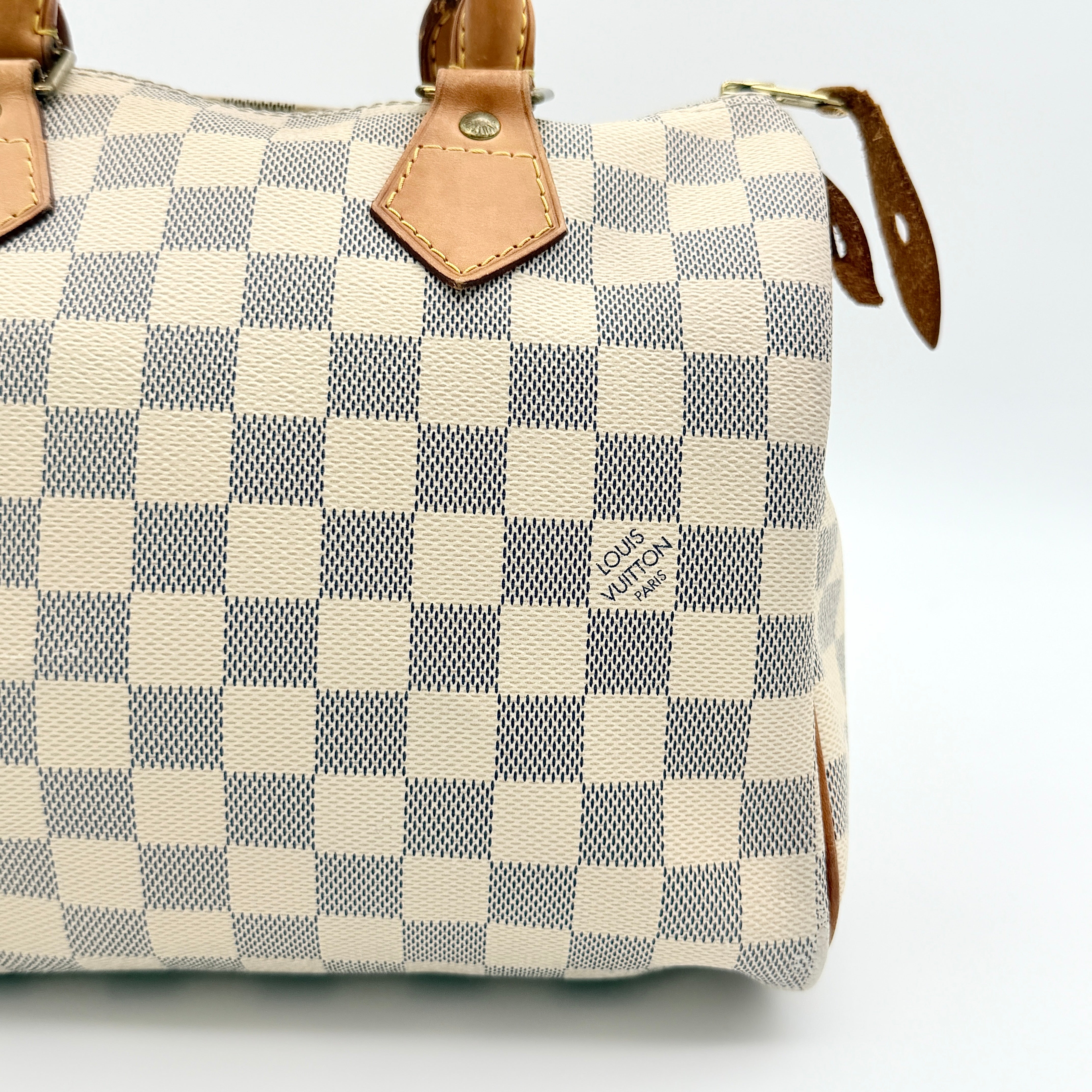 Louis Vuitton Damier Azur Speedy 25 handbag with natural leather handles, brass hardware, and included LV padlock and keys.