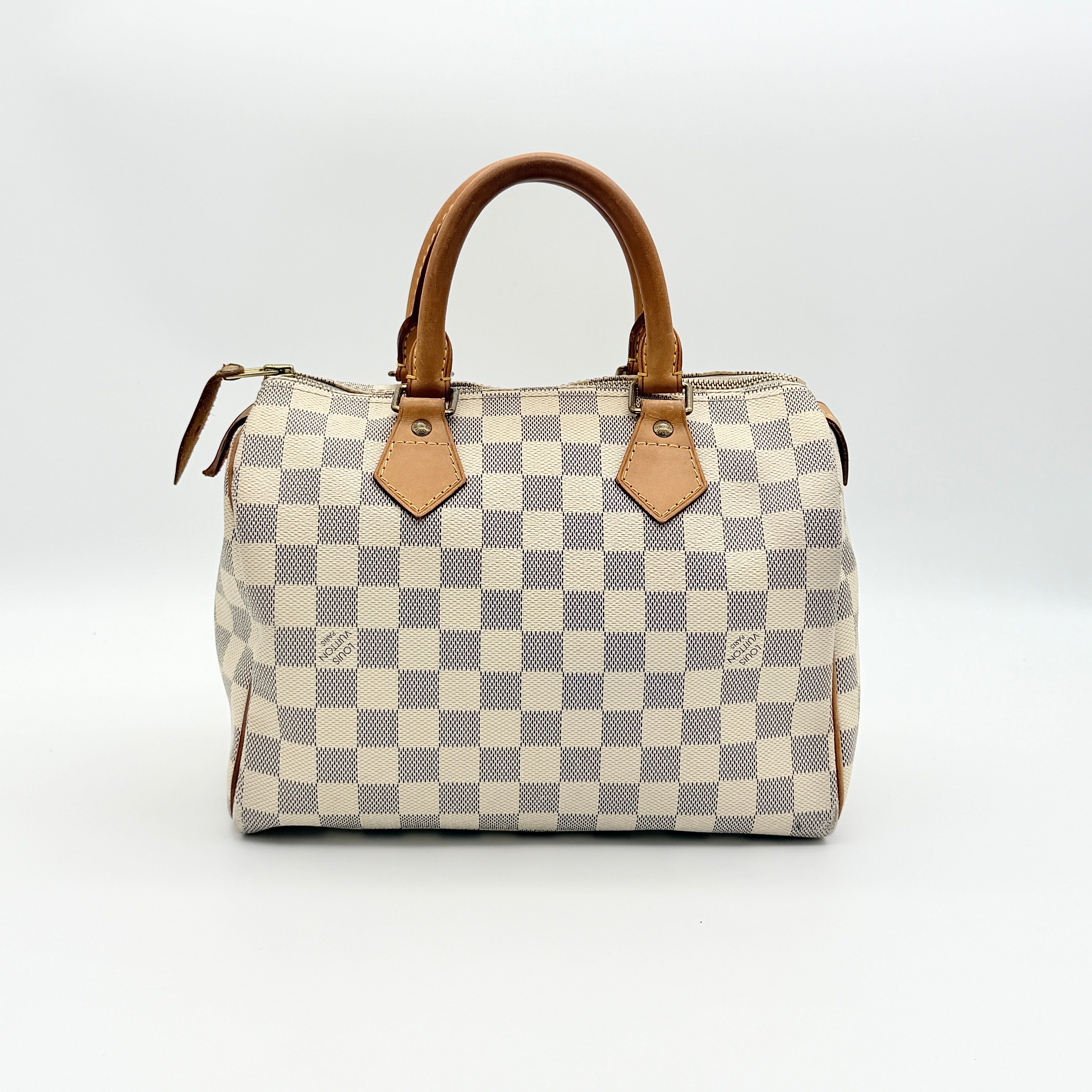Louis Vuitton Damier Azur Speedy 25 handbag with natural leather handles, brass hardware, and included LV padlock and keys.