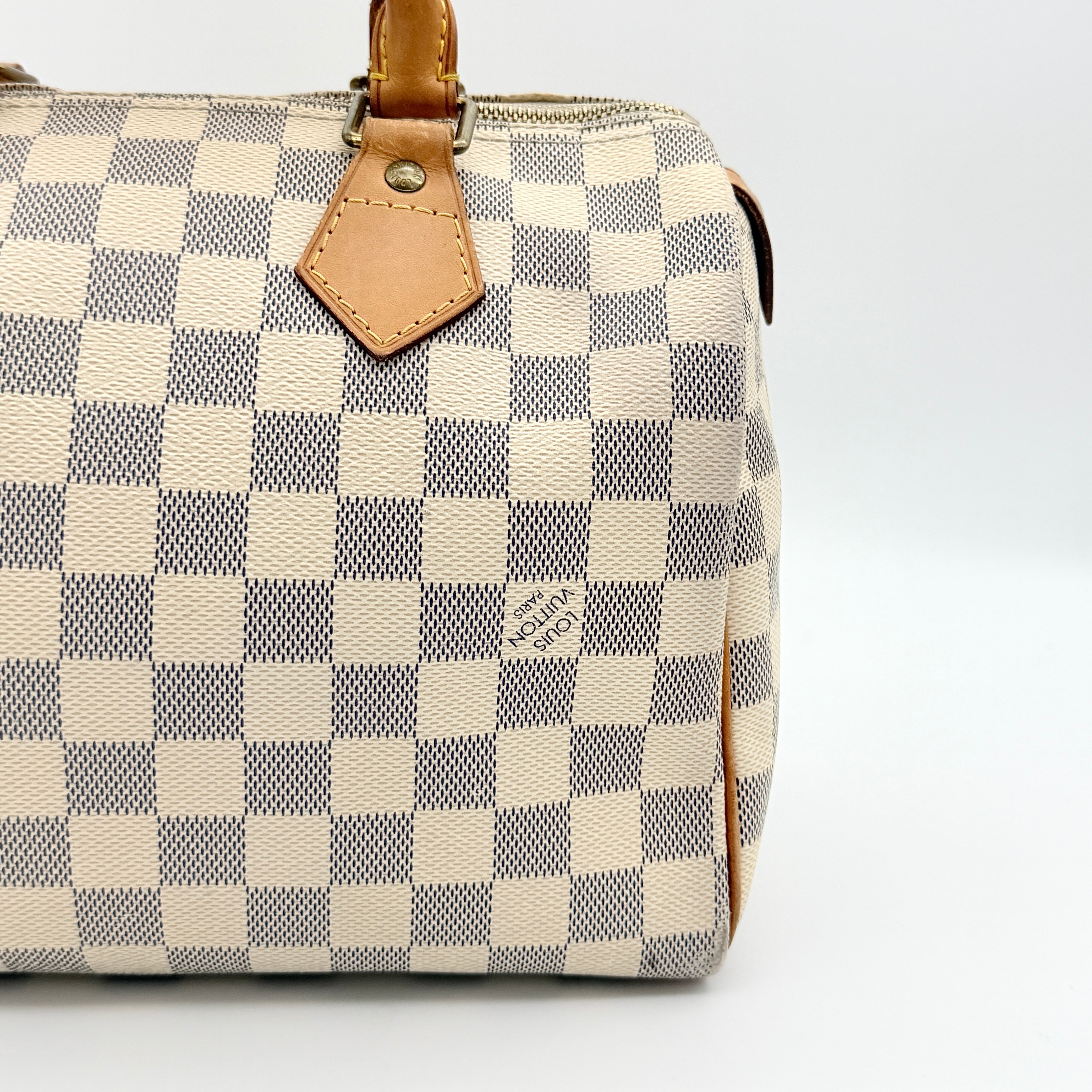 Louis Vuitton Damier Azur Speedy 25 handbag with natural leather handles, brass hardware, and included LV padlock and keys.