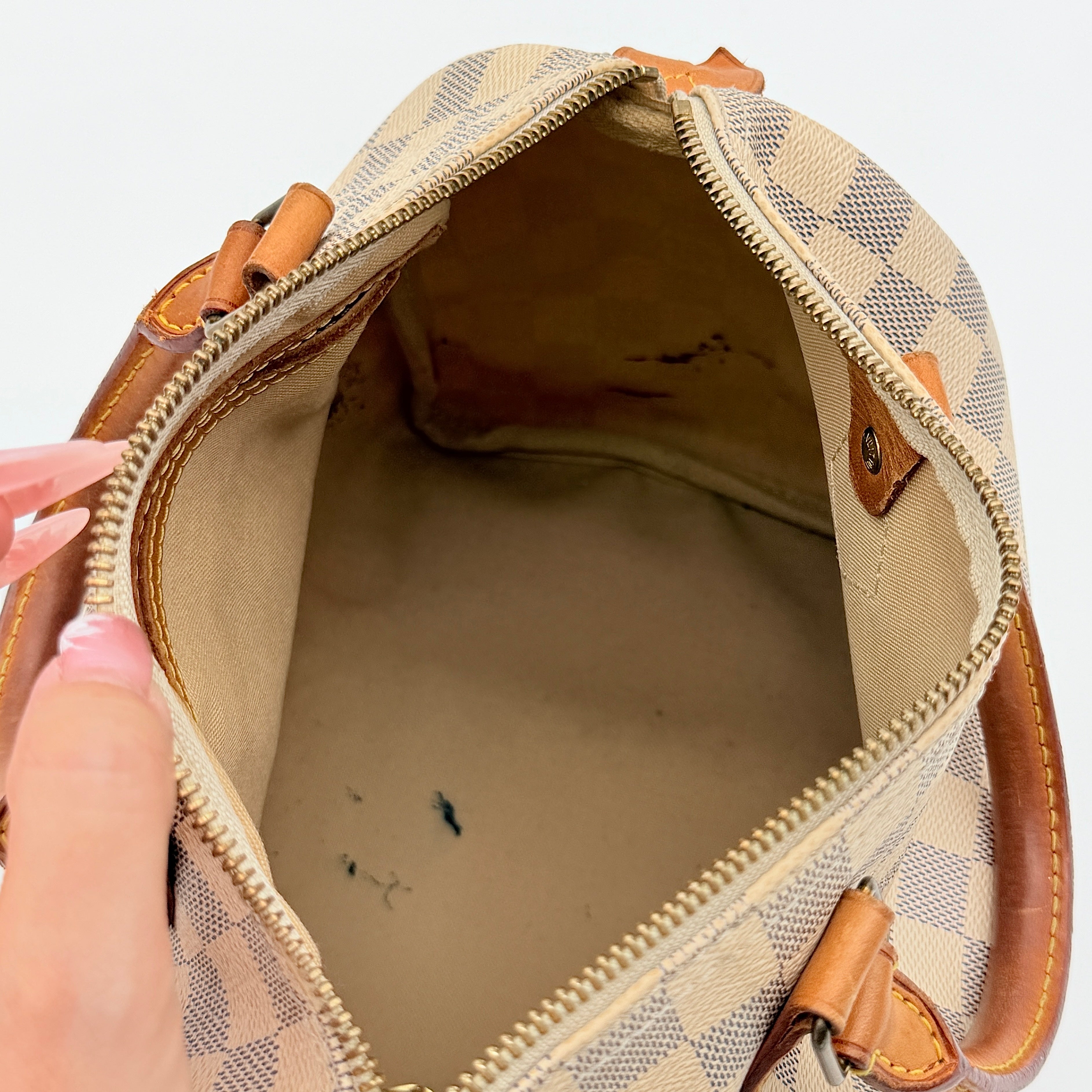 Louis Vuitton Damier Azur Speedy 25 handbag with natural leather handles, brass hardware, and included LV padlock and keys.