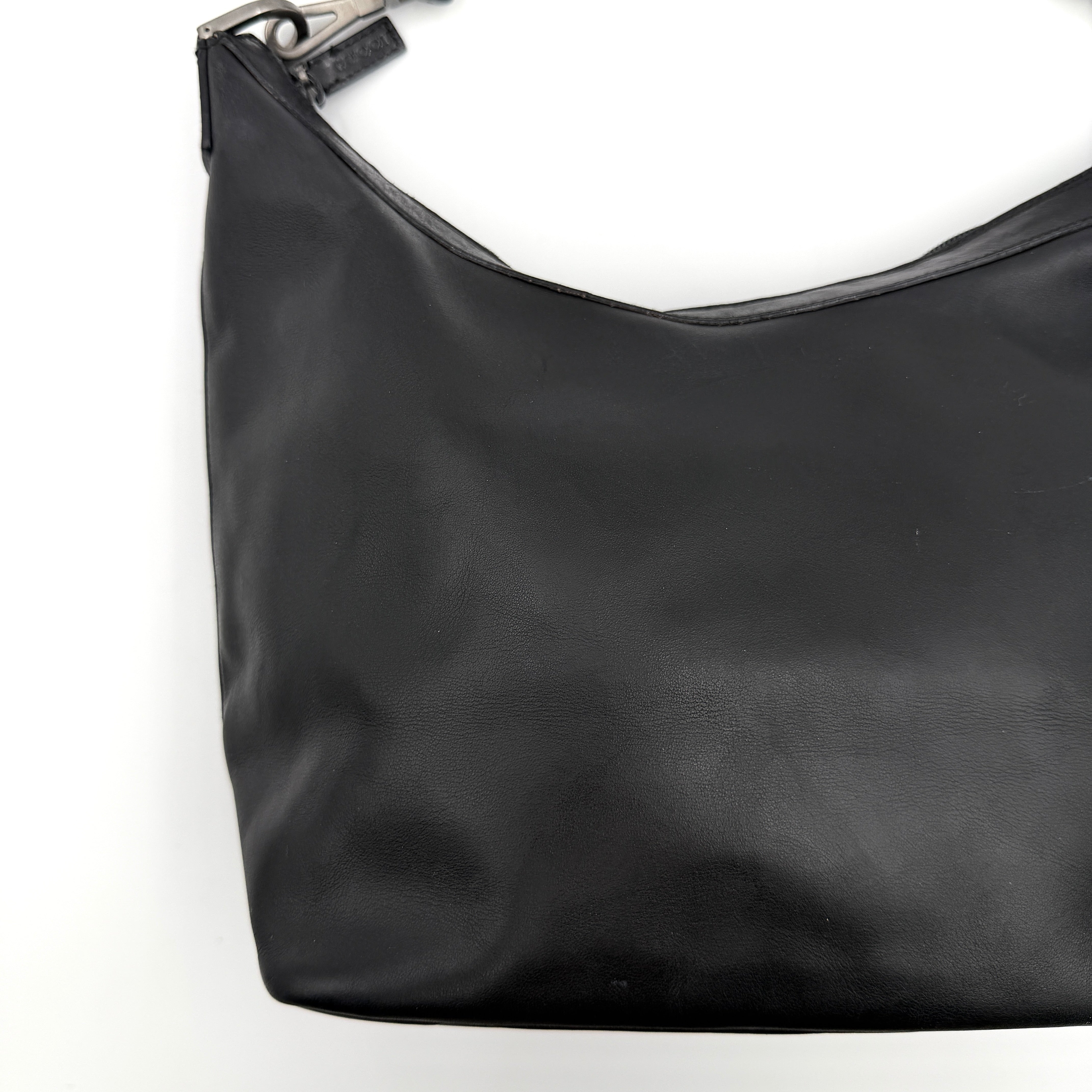 Gucci black leather hobo bag with bamboo handle and silver-tone hardware shown against a white background.