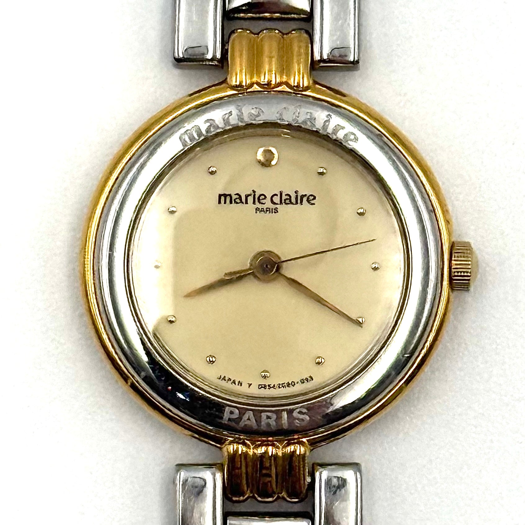 Marie Claire Paris 085268-00 two-tone gold and silver watch with a champagne dial, shown on a black pillow.