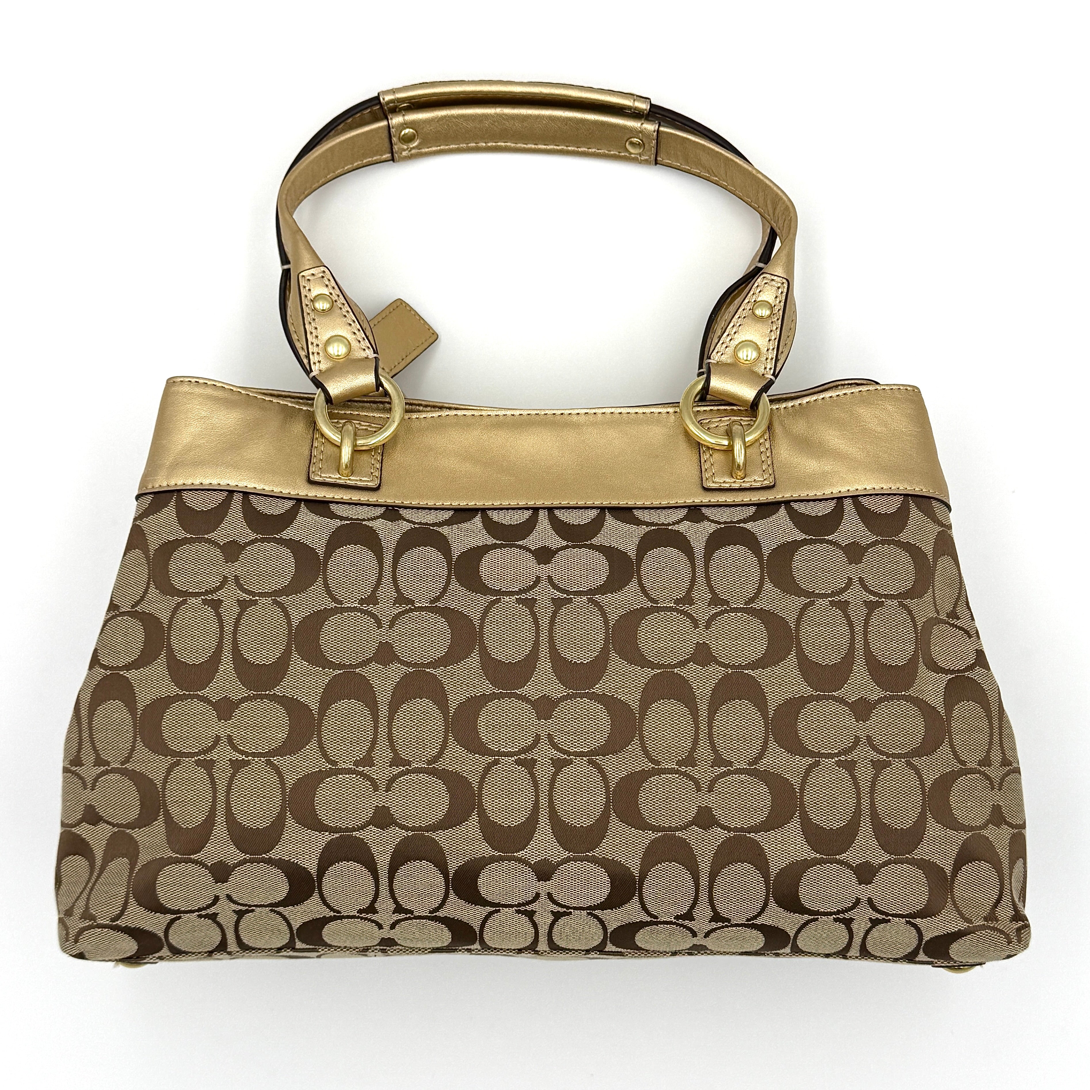 Coach Signature Penelope Shoulder Bag in beige monogram canvas with gold leather trim and gold-tone hardware displayed upright.
