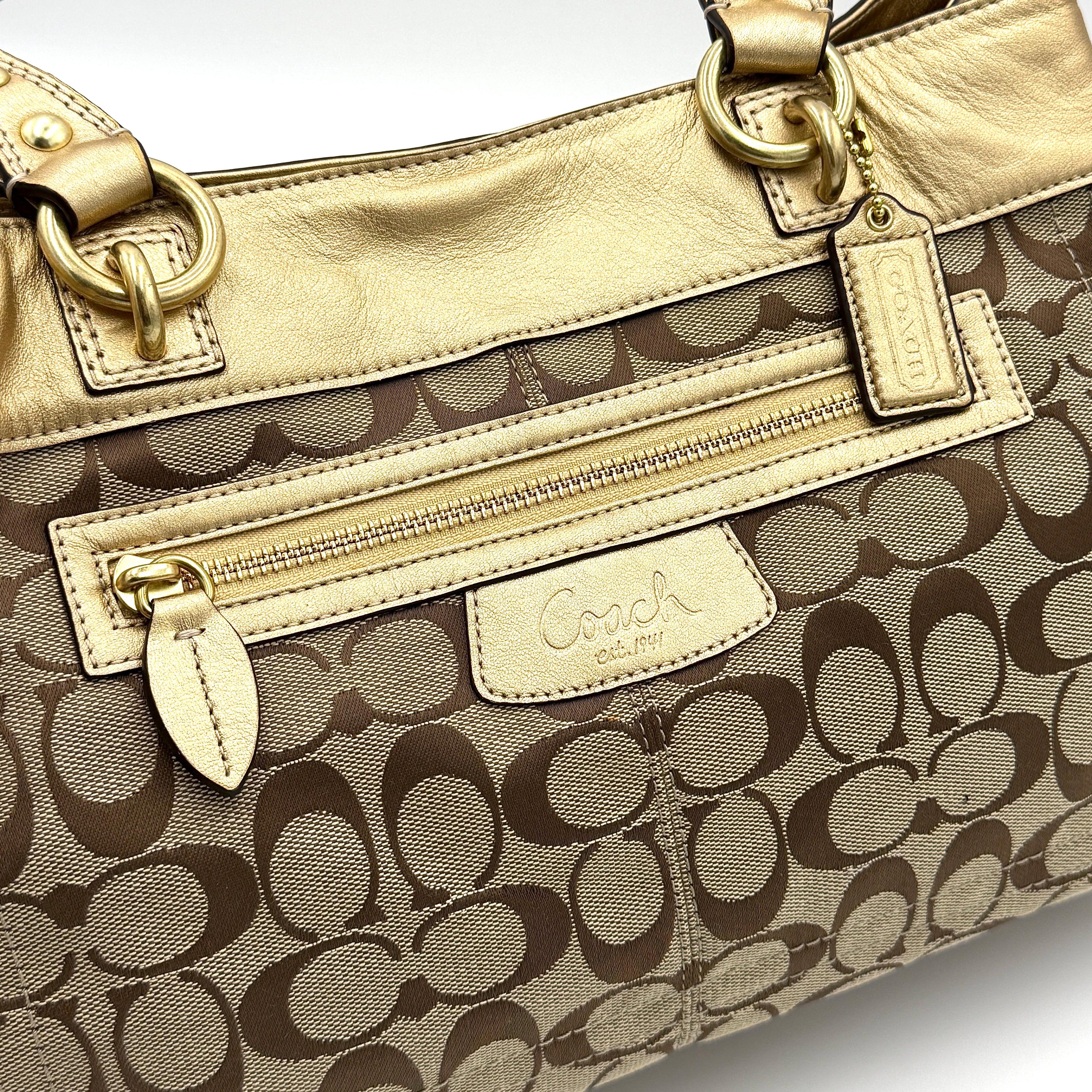 Coach Signature Penelope Shoulder Bag in beige monogram canvas with gold leather trim and gold-tone hardware displayed upright.