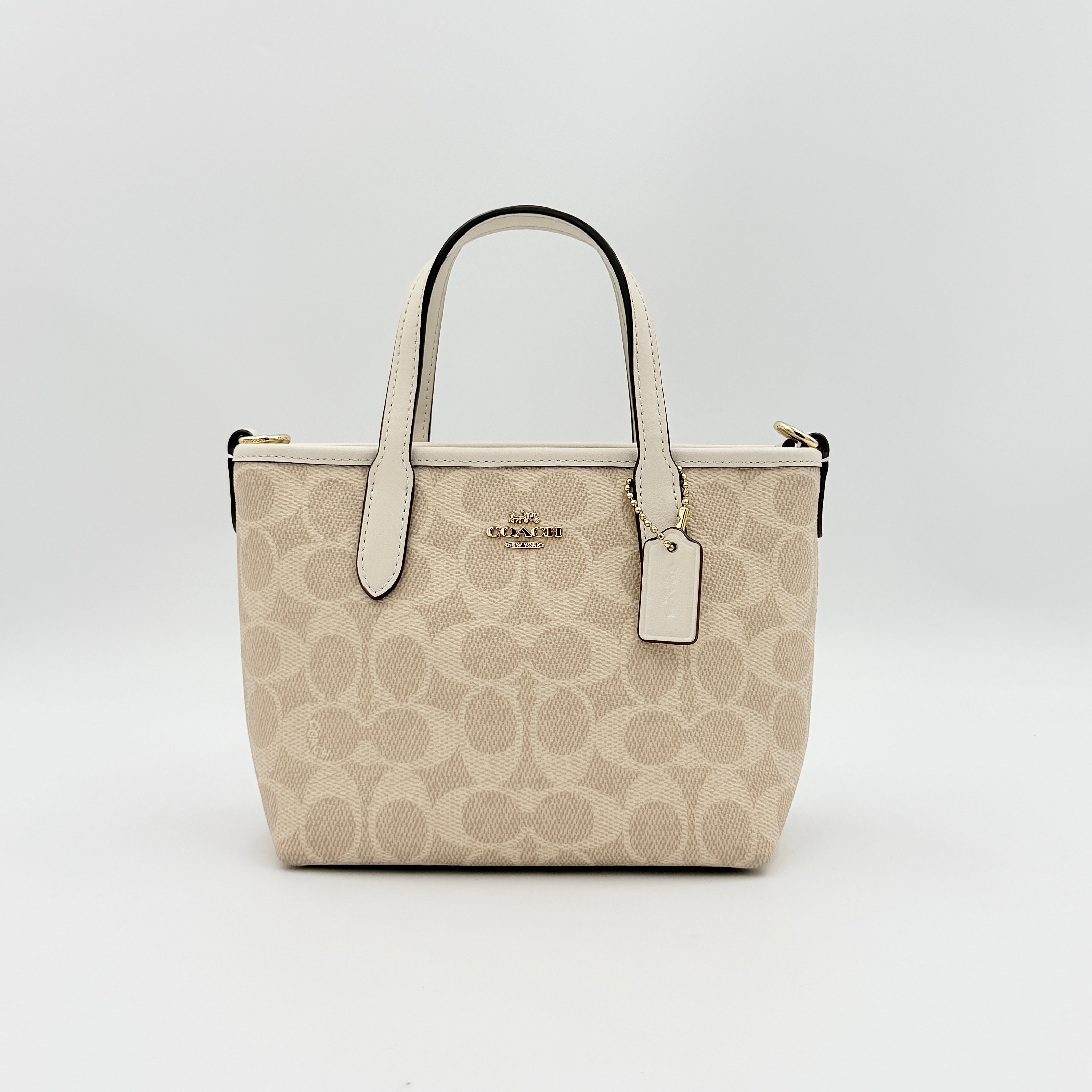 Coach 2Way Mini City Tote in beige and white with signature jacquard, shown with detachable logo canvas strap.