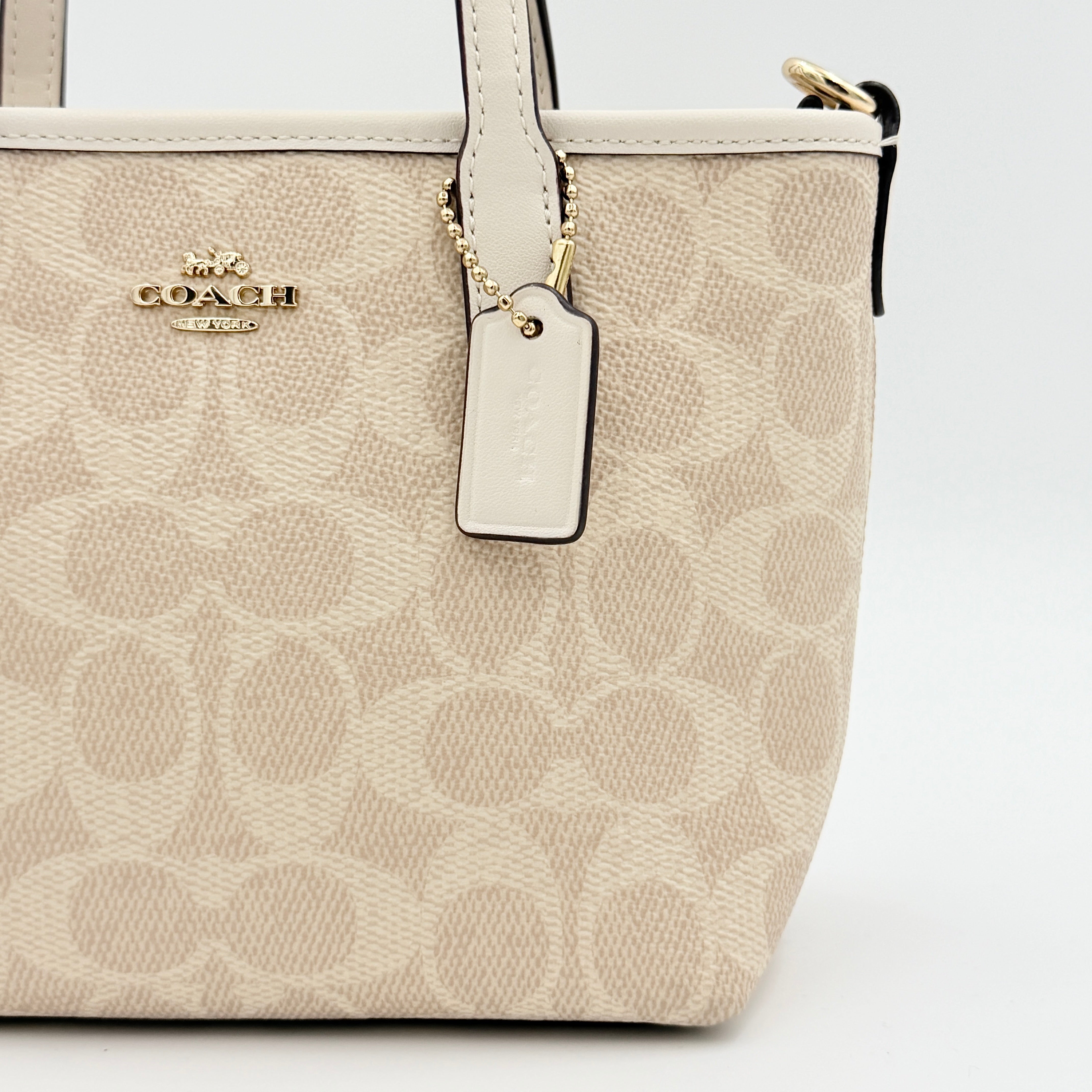 Coach 2Way Mini City Tote in beige and white with signature jacquard, shown with detachable logo canvas strap.