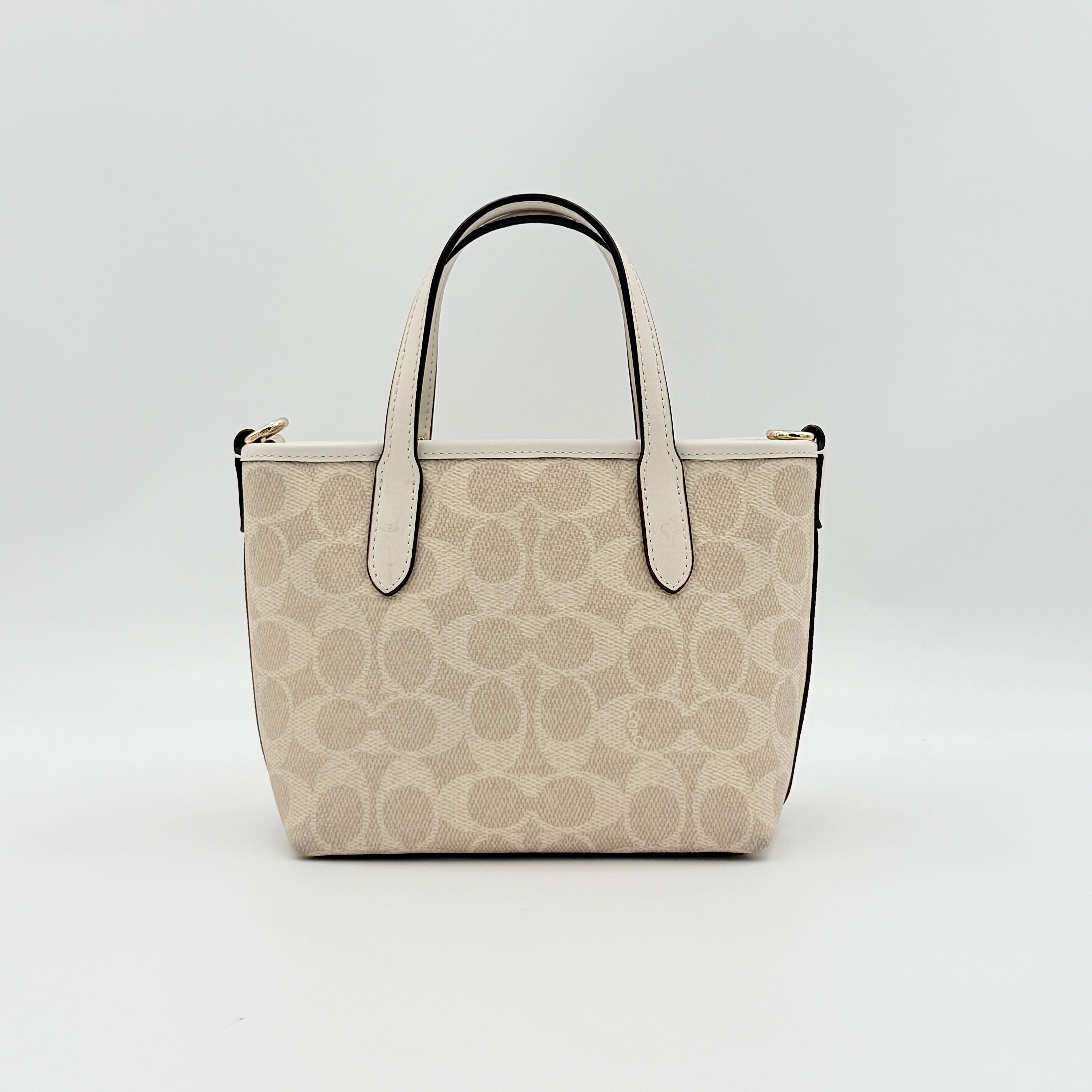 Coach 2Way Mini City Tote in beige and white with signature jacquard, shown with detachable logo canvas strap.