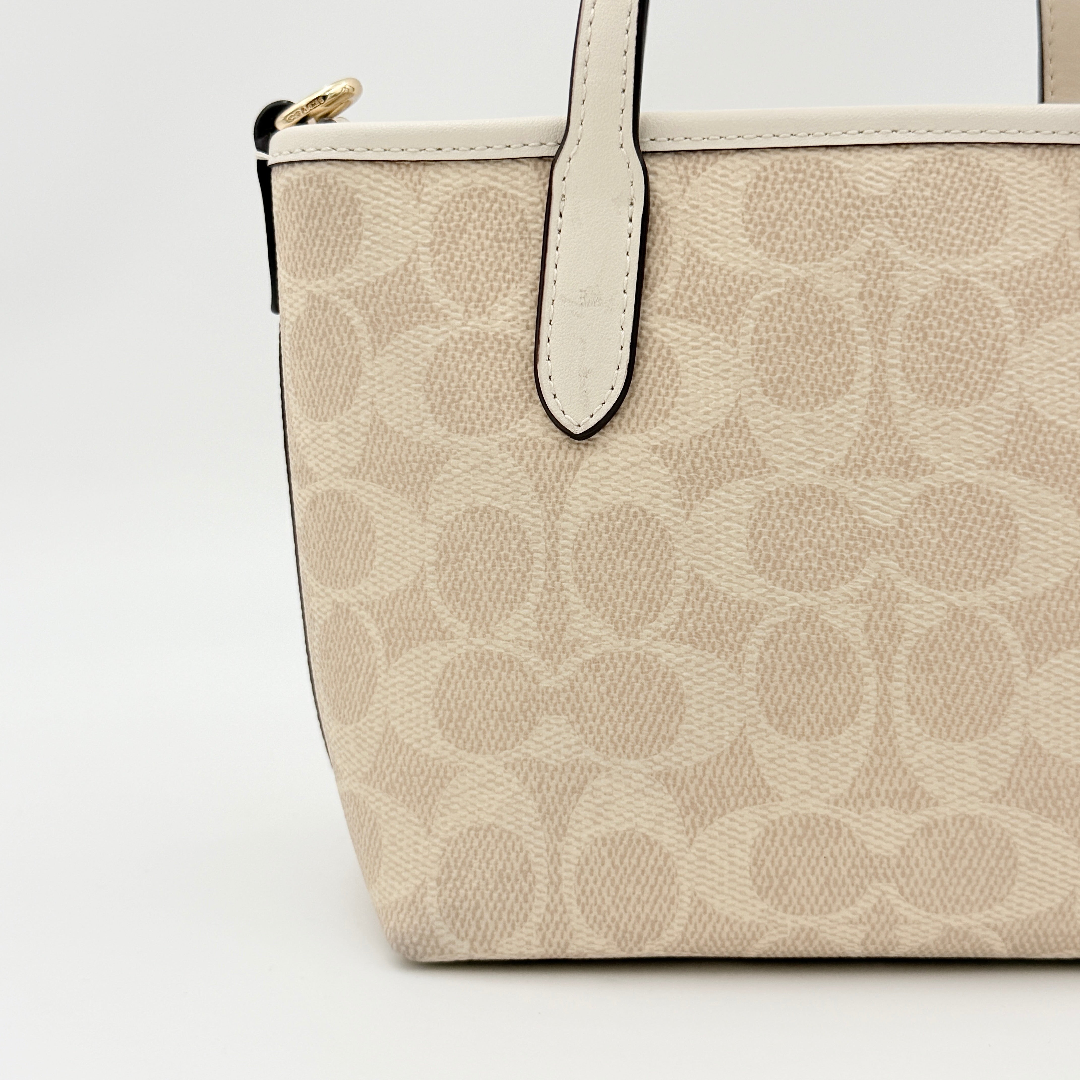 Coach 2Way Mini City Tote in beige and white with signature jacquard, shown with detachable logo canvas strap.